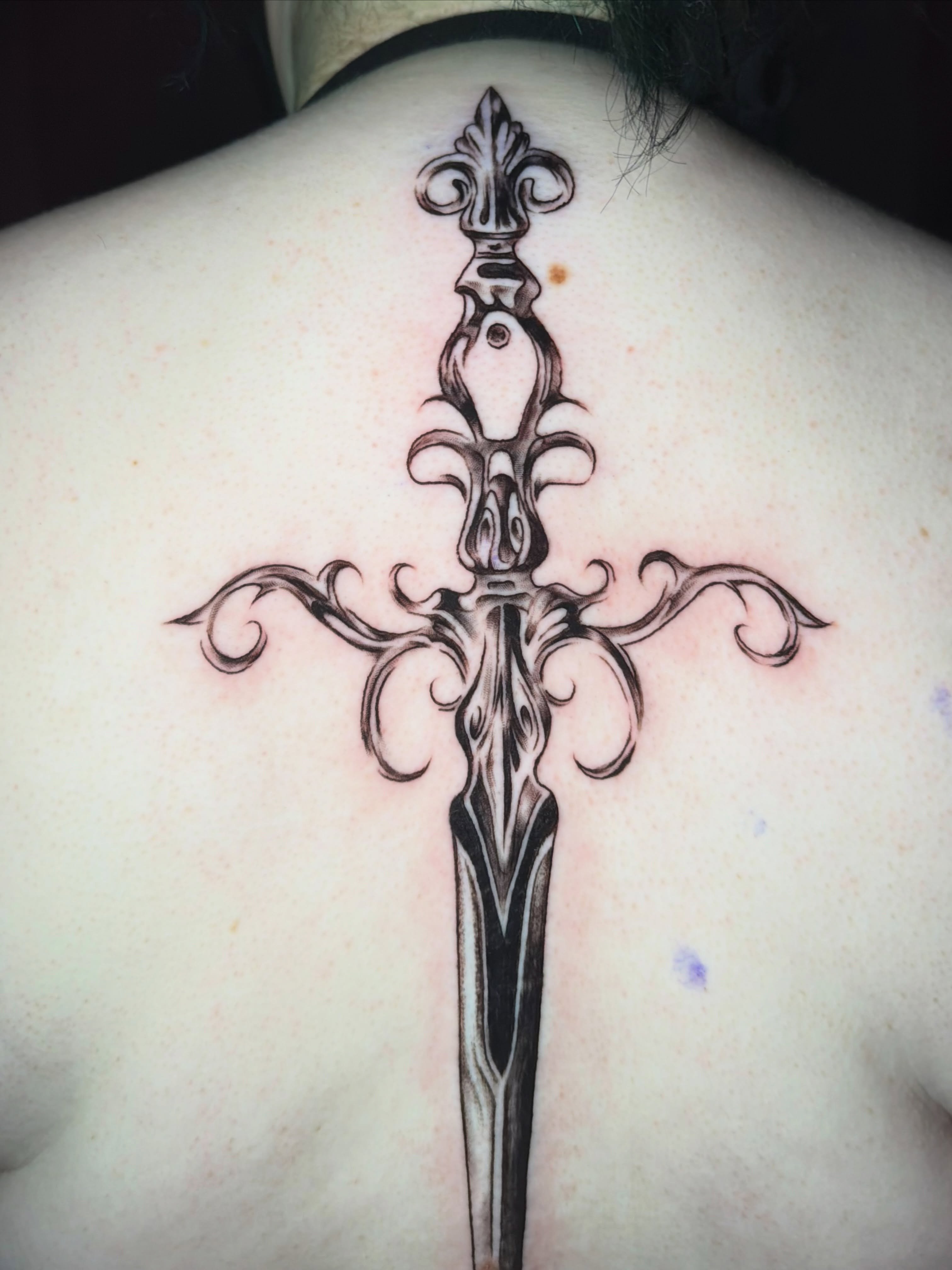 Sword ornamental tattoo on the back by tattoo artist (mollz)