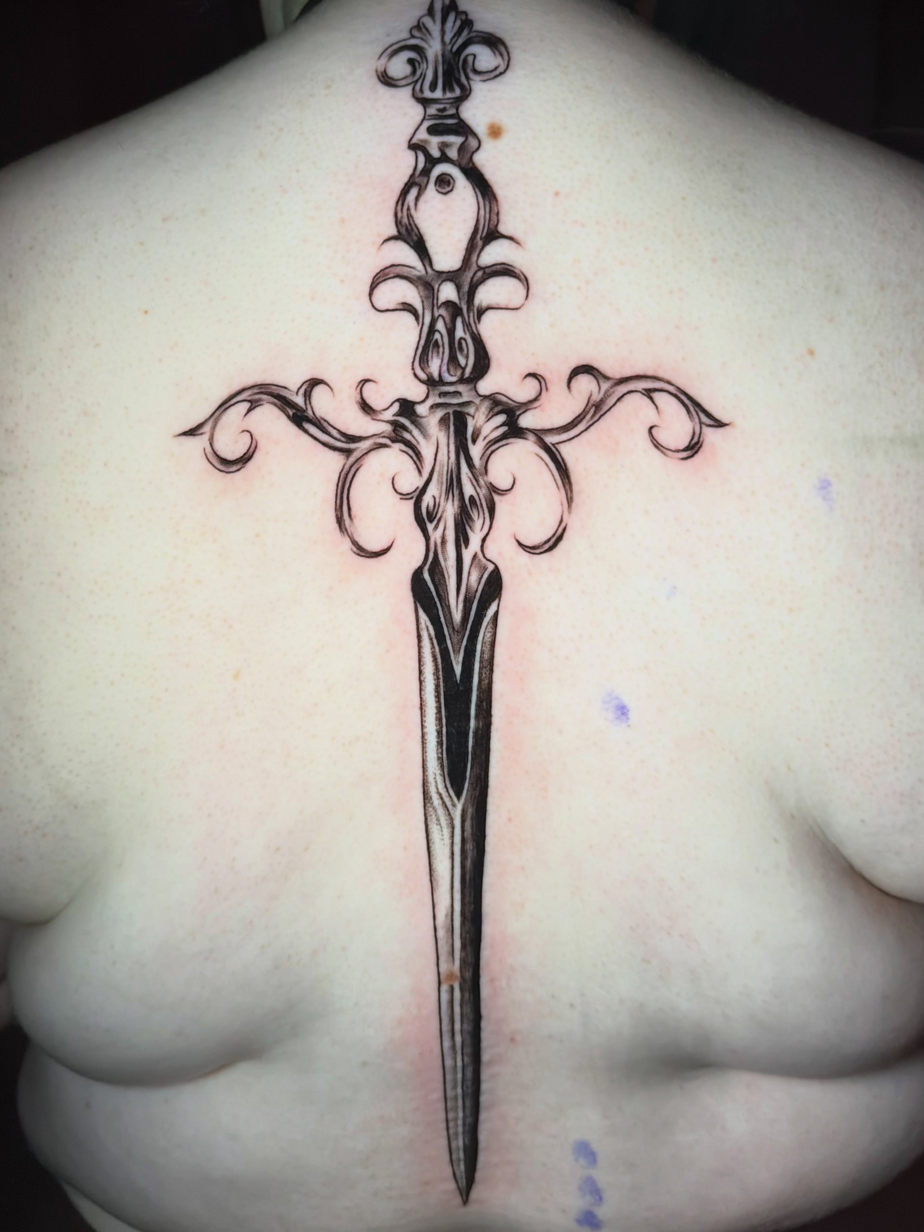 Sword ornamental tattoo on the back by tattoo artist (mollz)