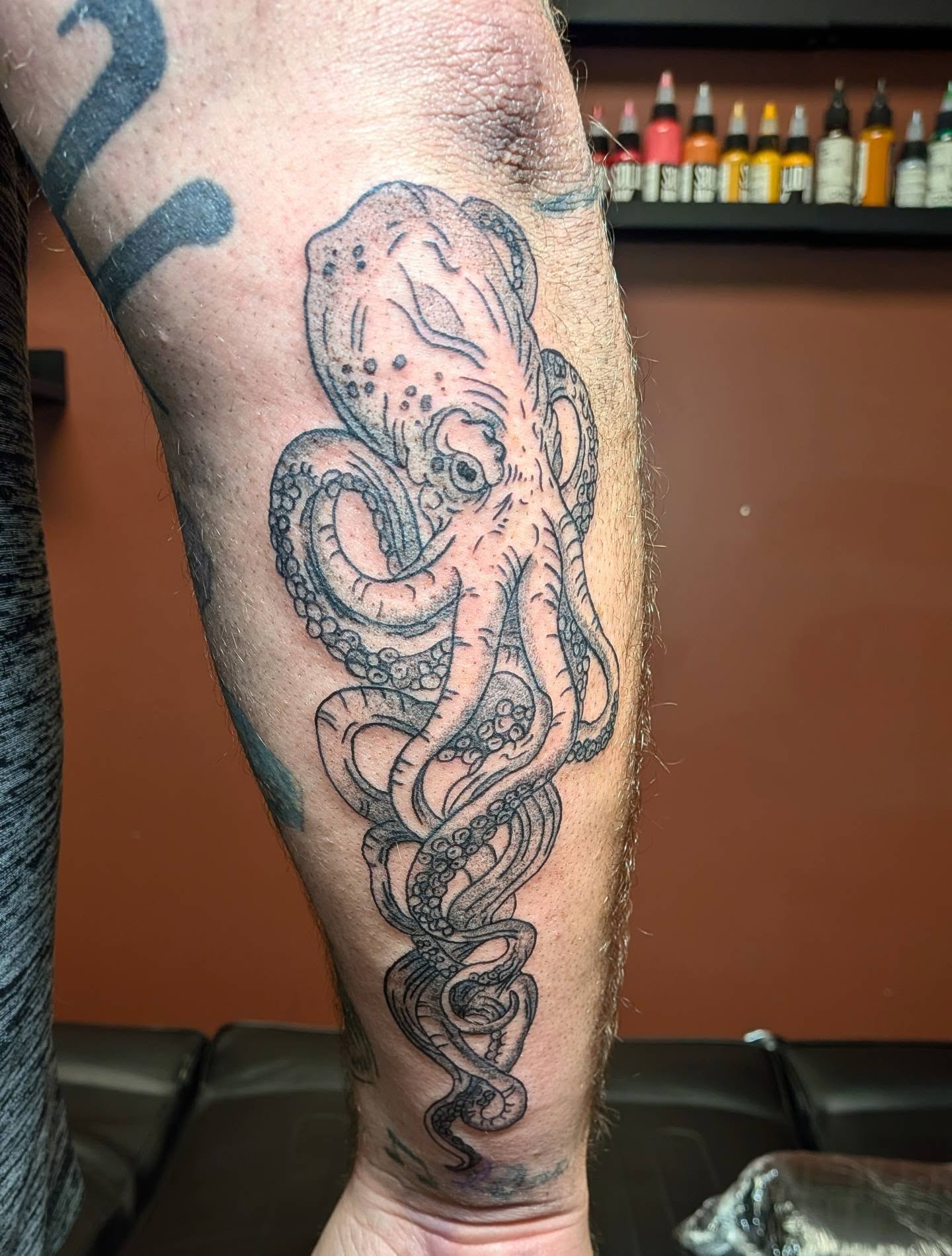 Octopus American traditional tattoo on the forearm by Kam