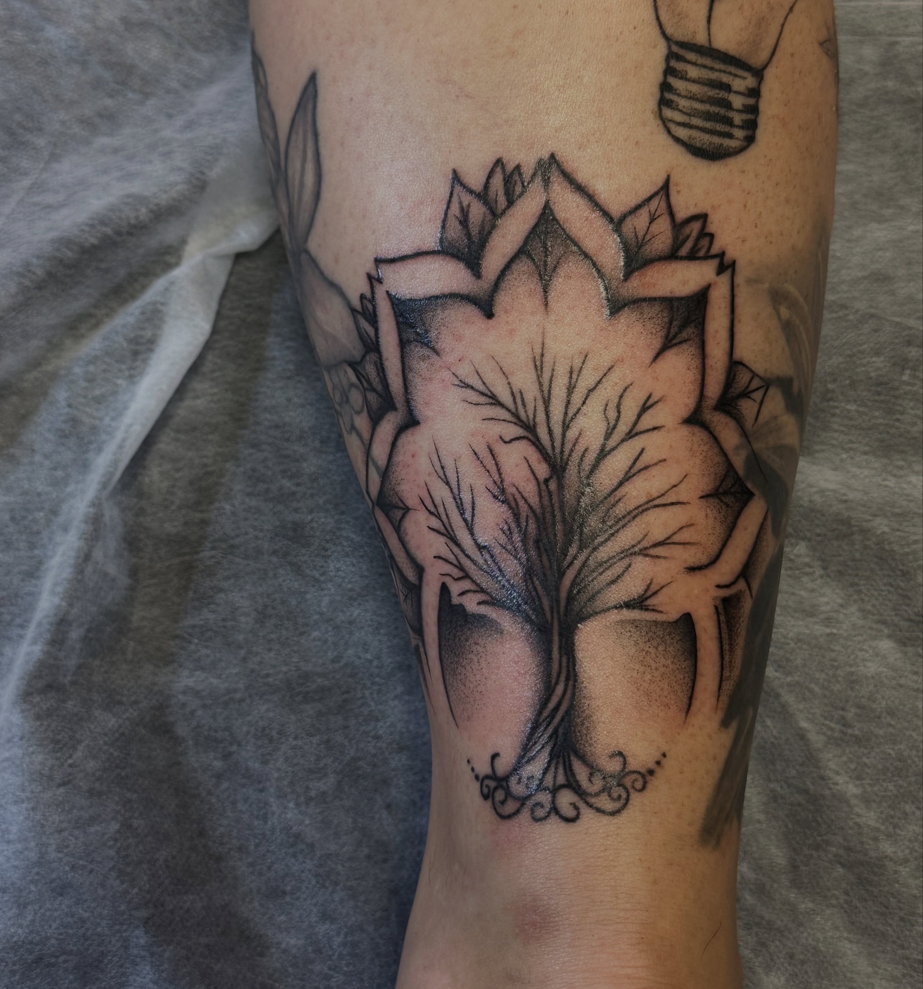 Lotus flower geometric tattoo on the forearm by Jocelyn
