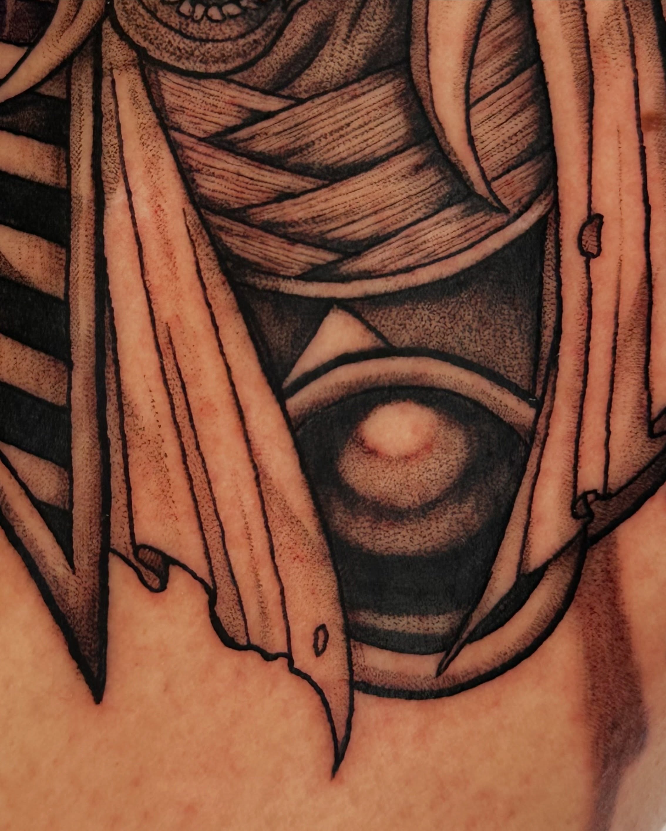 Eye with feathers geometric tattoo on the chest by Taylin Johnson- Illustrative Blackwork, Columbus, Ohio