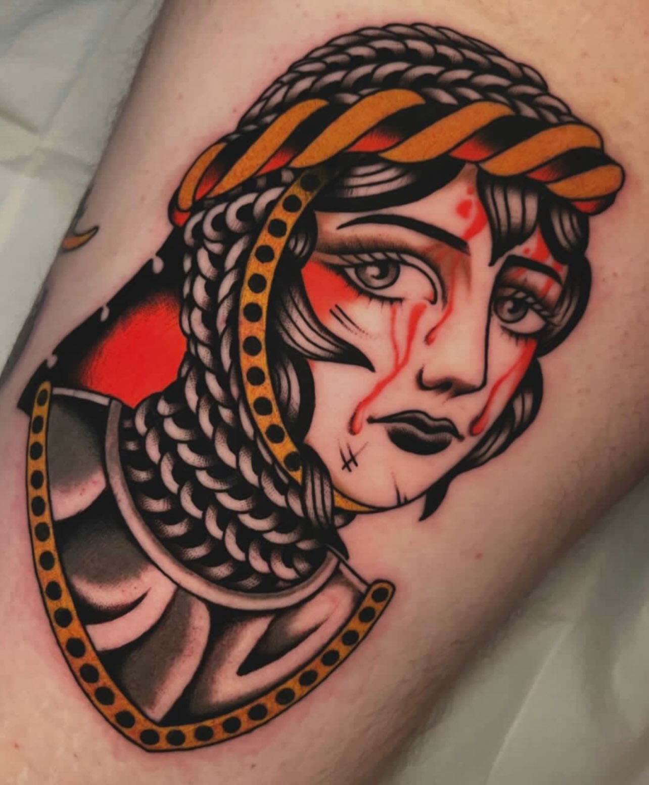 Woman with braided hair American traditional tattoo on the forearm by Hailey Johnson
