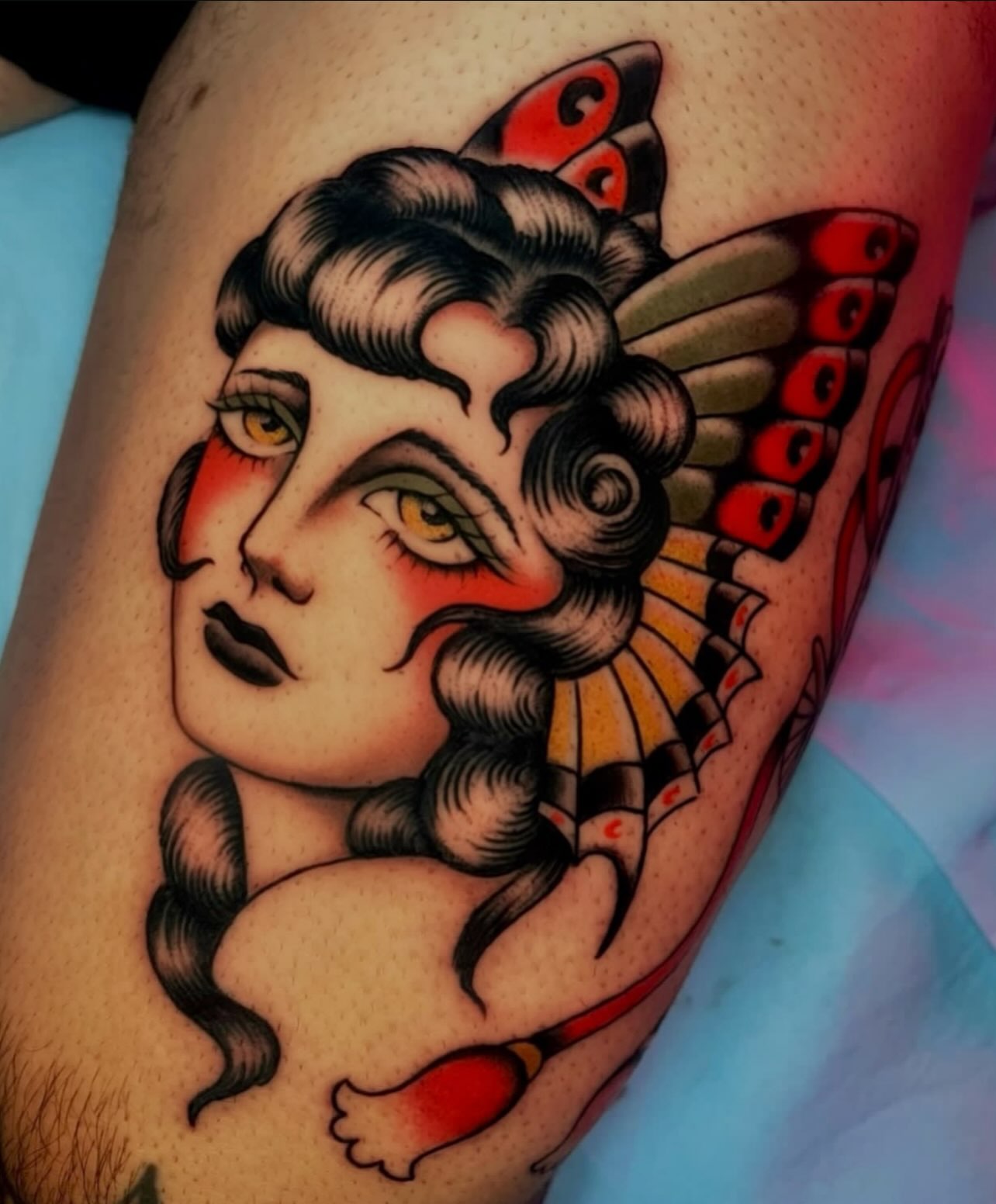 Woman with butterfly wings American traditional tattoo on the thigh by Hailey Johnson