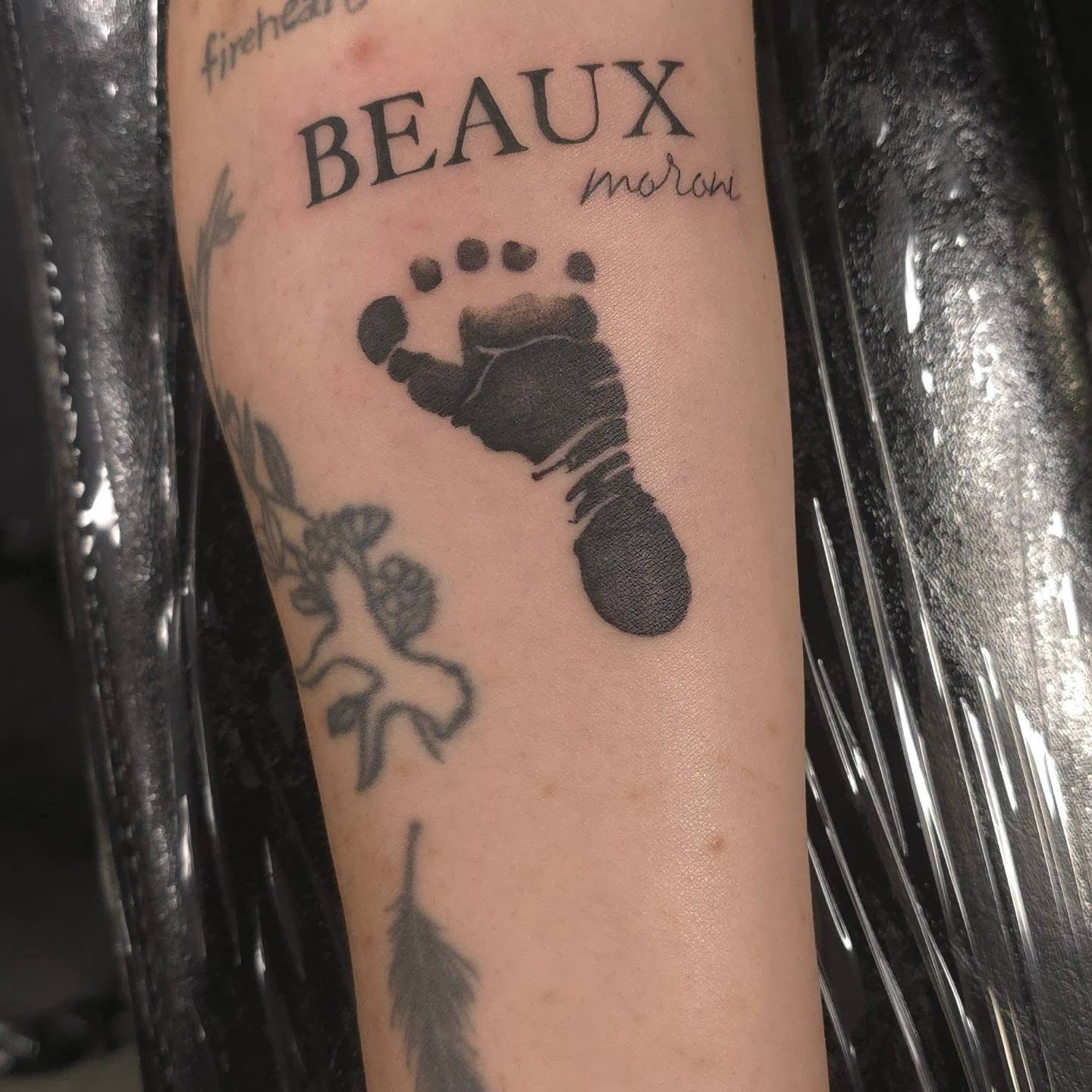 Footprint black and grey tattoo on the forearm by Trinity