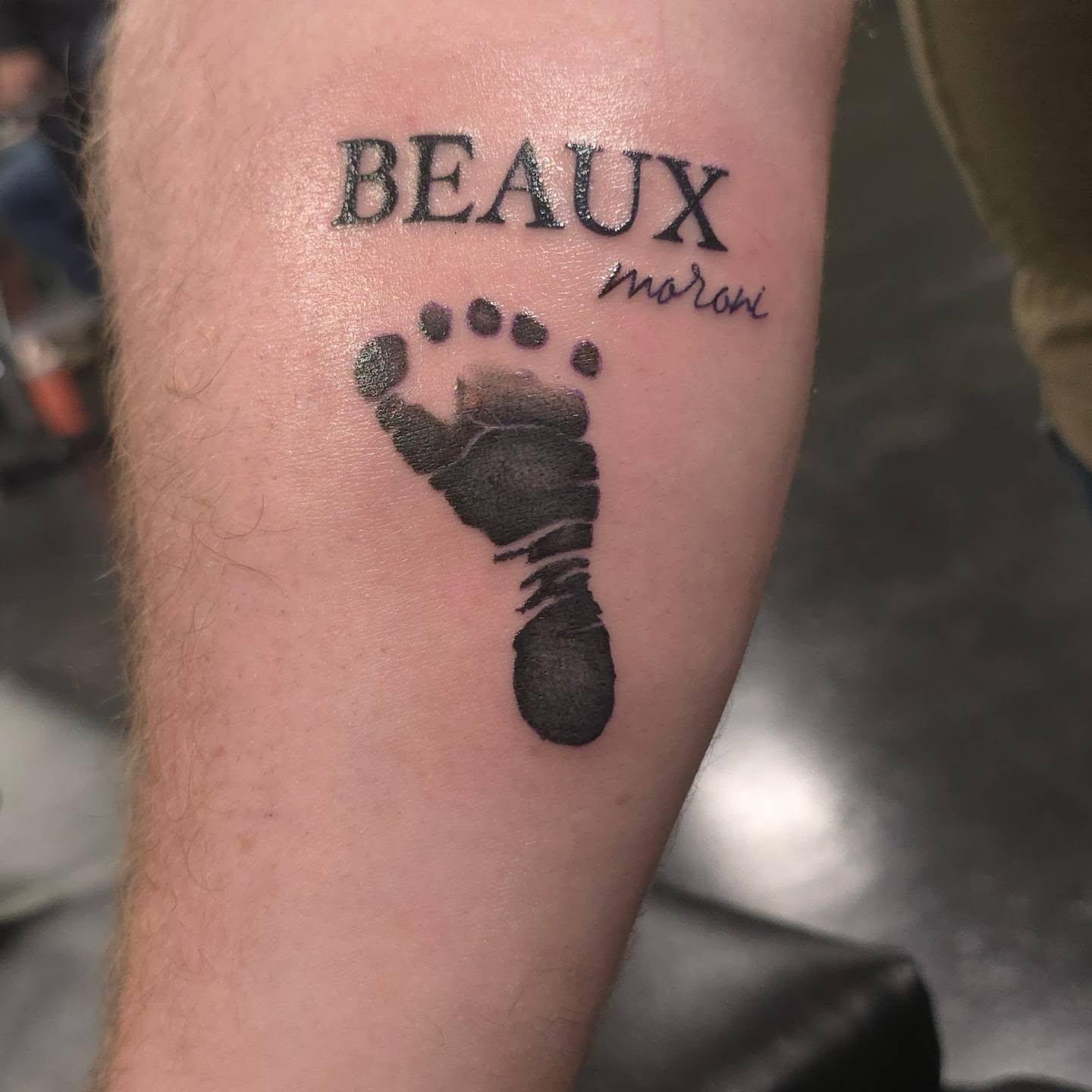 Footprint black and grey tattoo on the forearm by Trinity