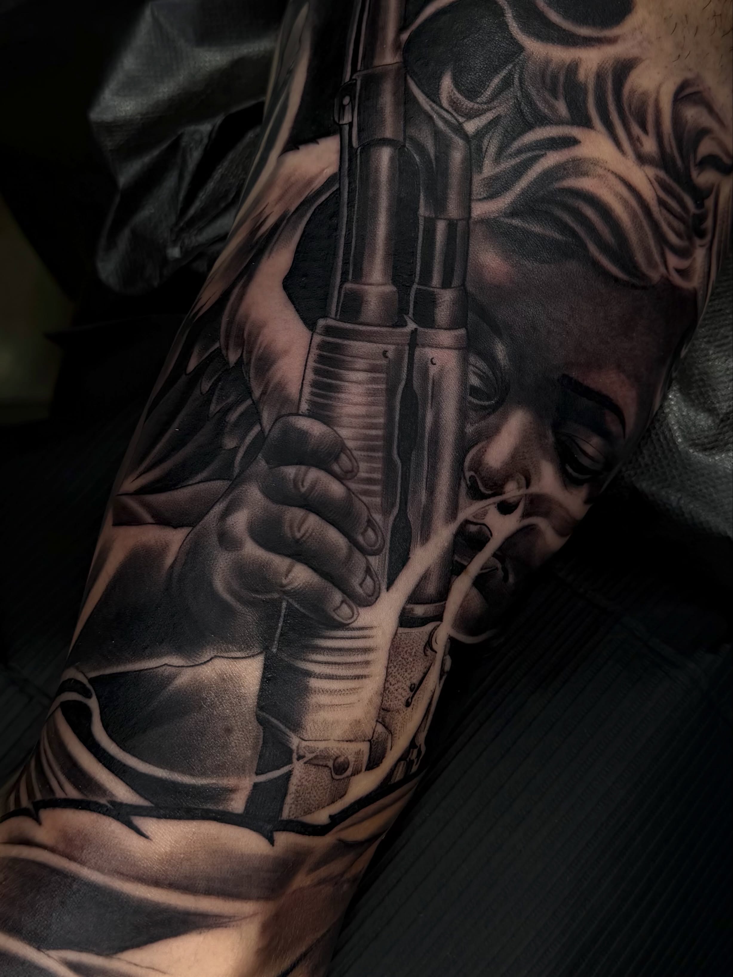 Man holding gun realism tattoo on the forearm by San Diego Tattoo Artist