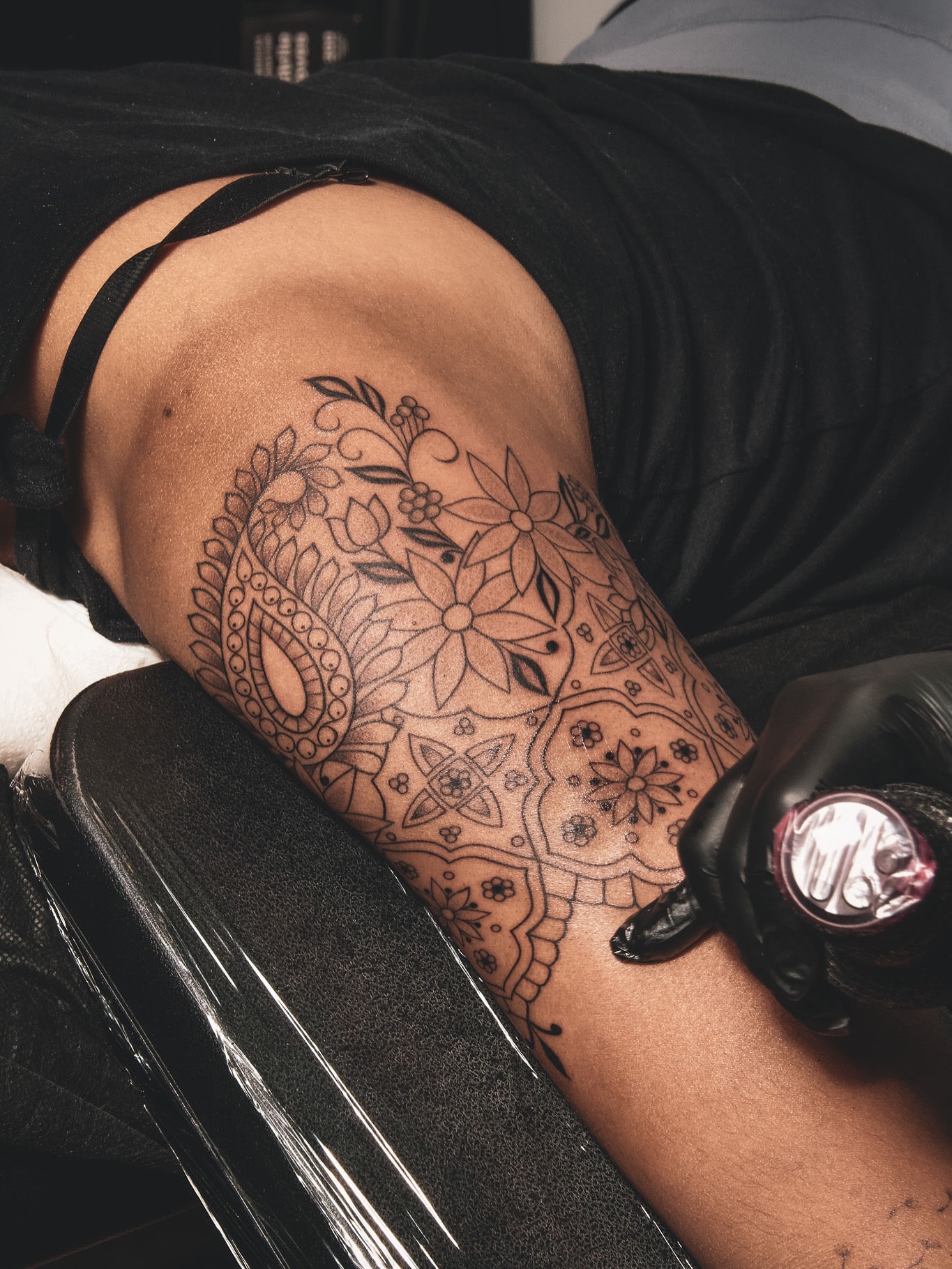 Floral mandala geometric tattoo on the thigh by Sabreena Haque