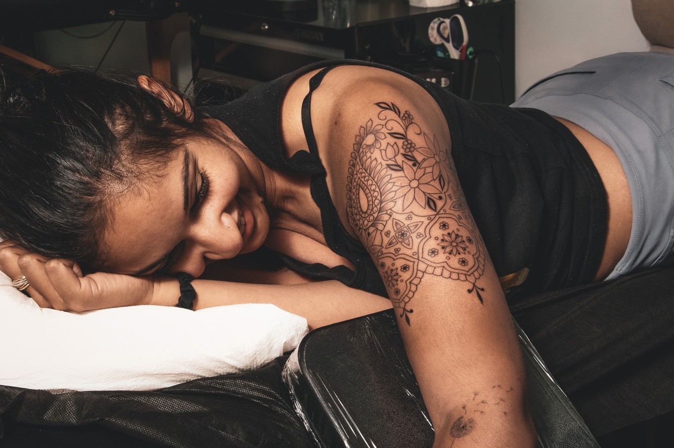 Mandala black and grey tattoo on the upper arm by Sabreena Haque