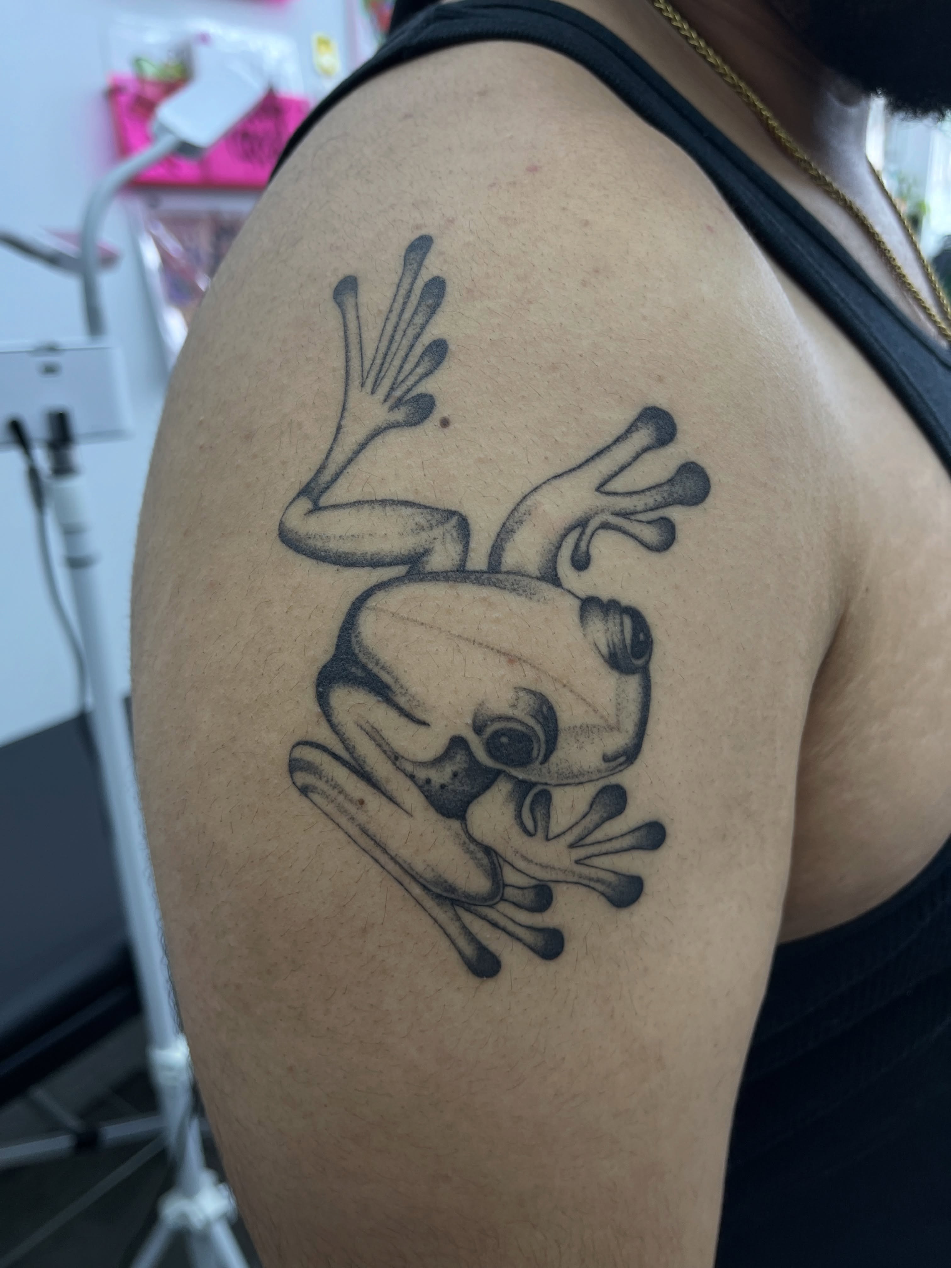 Frog black and grey tattoo on the shoulder by christina diaz