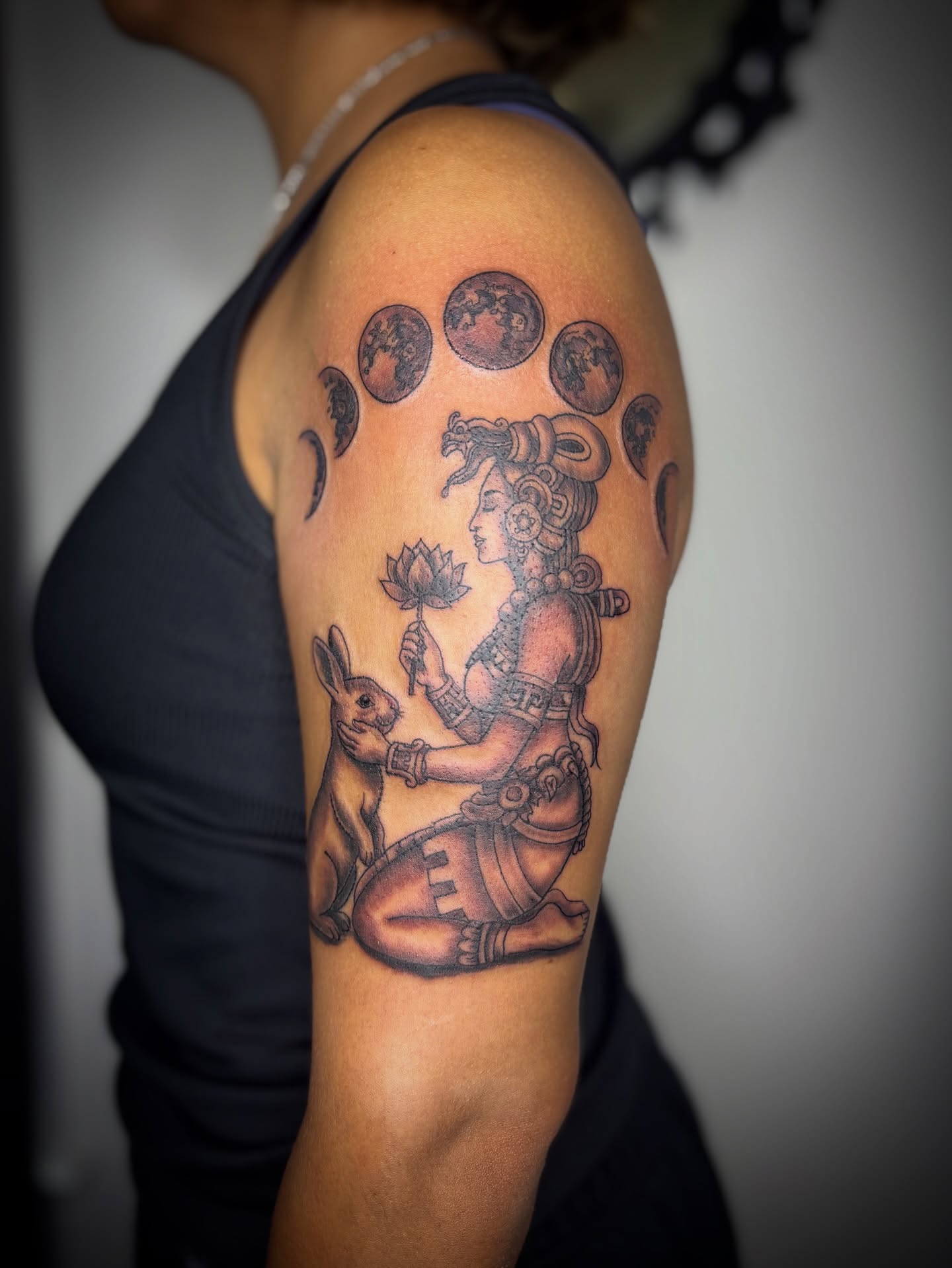 Woman with rabbit and lotus black and grey tattoo on the shoulder by Adrian Ram 🇬🇾🇵🇭