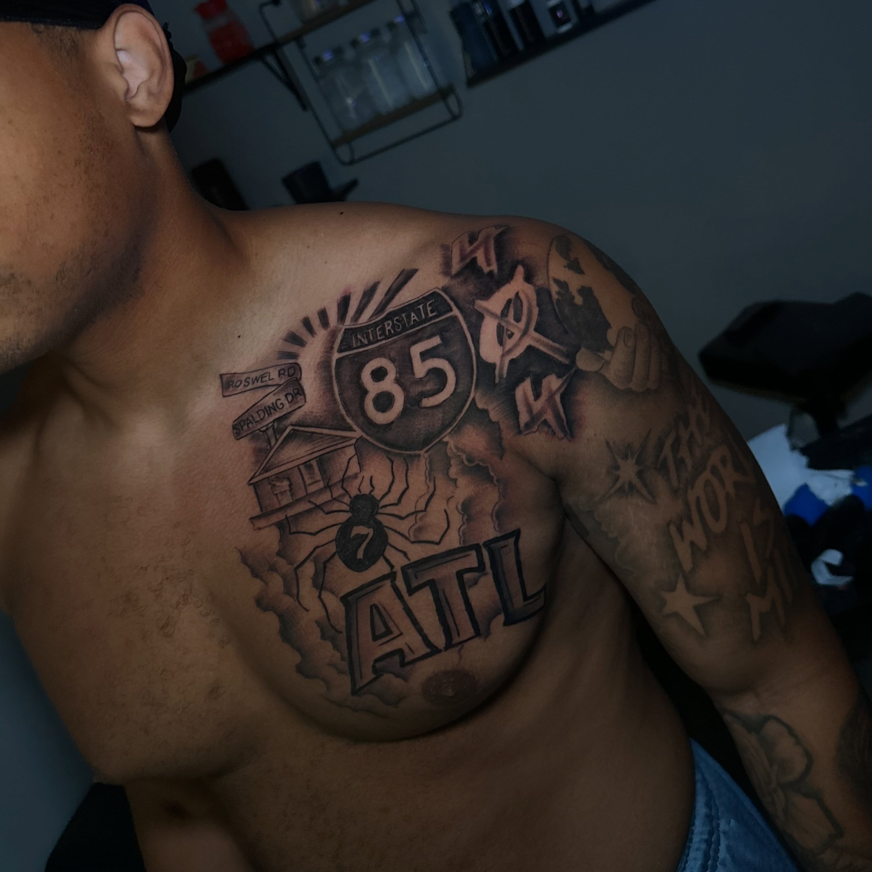 Interstate highway sign black and grey tattoo on the chest by @tattedbytuck