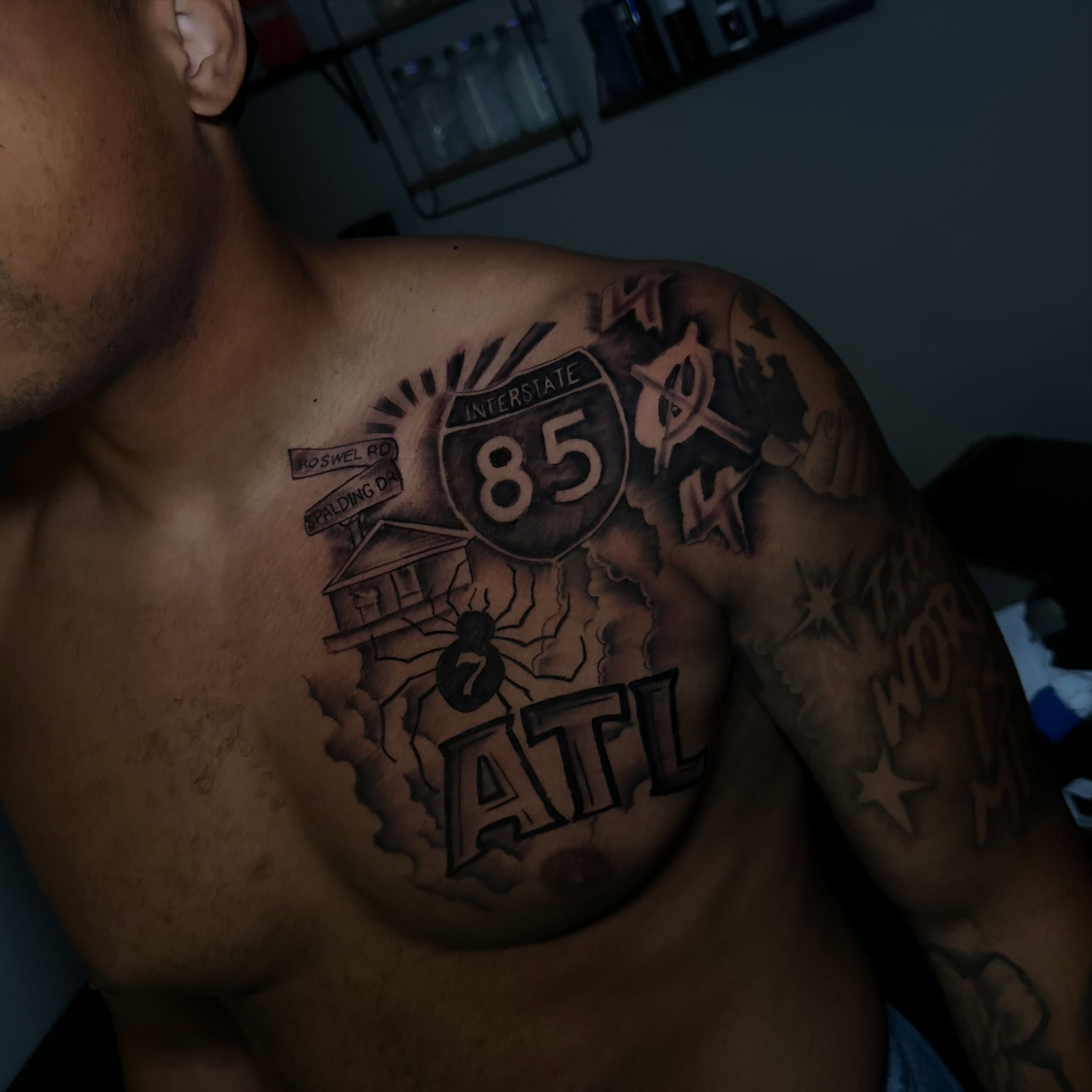 Interstate highway sign black and grey tattoo on the chest by @tattedbytuck