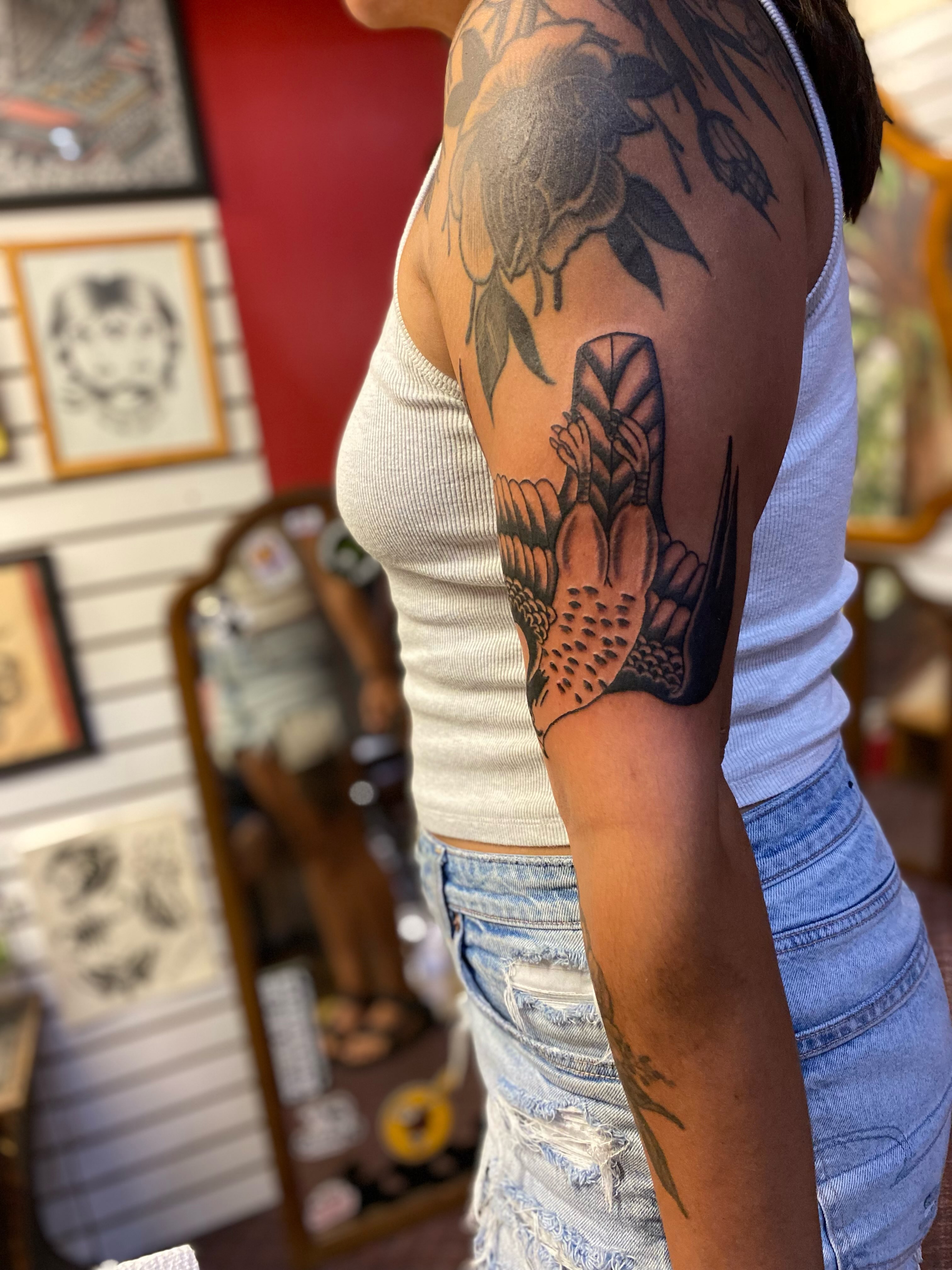 Peony and bird American traditional tattoo on the upper arm by Tommy O'Connell