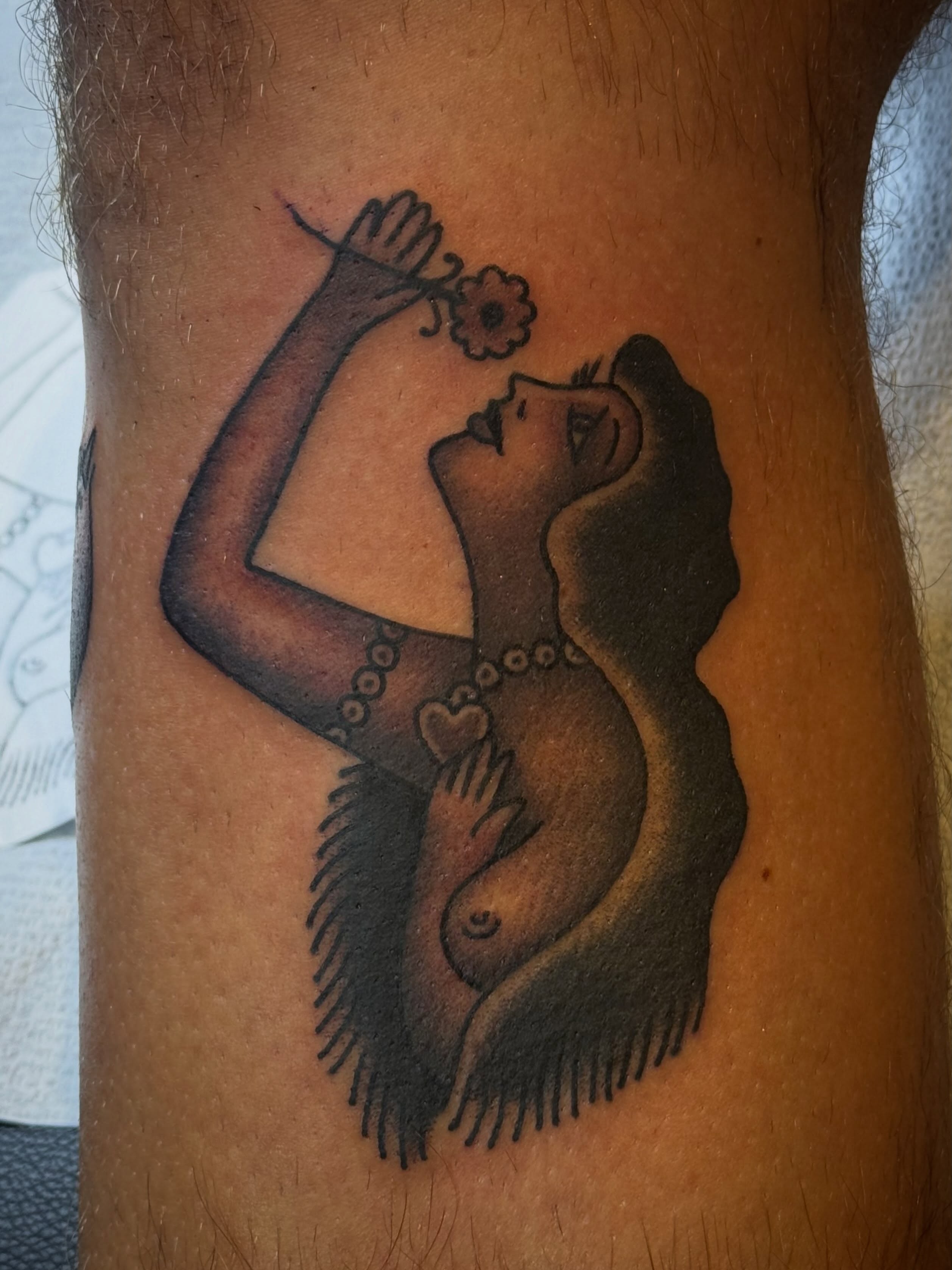 Woman with flower American traditional tattoo on the forearm by Laurent Trelaun, San Francisco, California