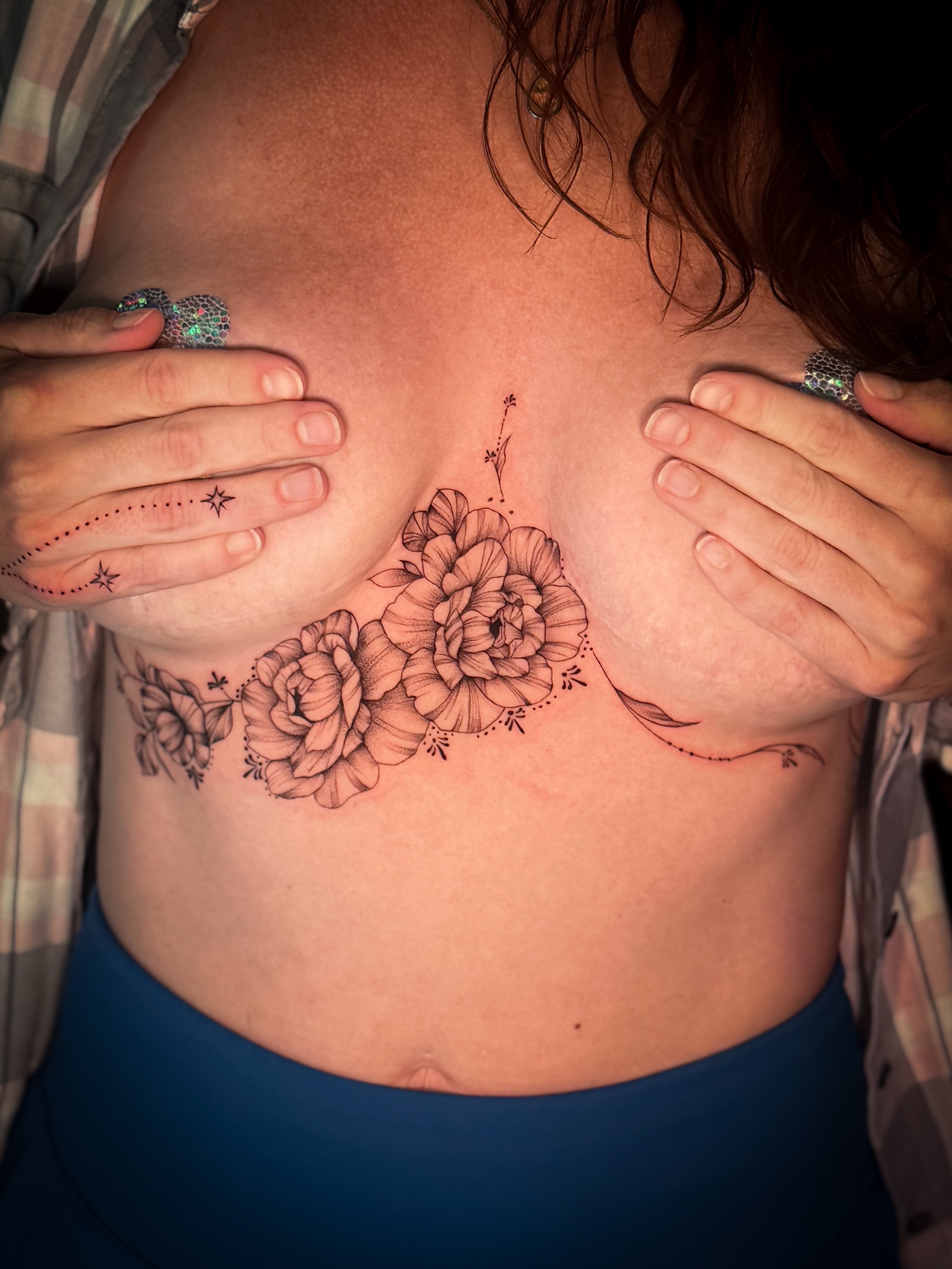 Floral bouquet black and grey tattoo on the chest by Jennifer Ramirez