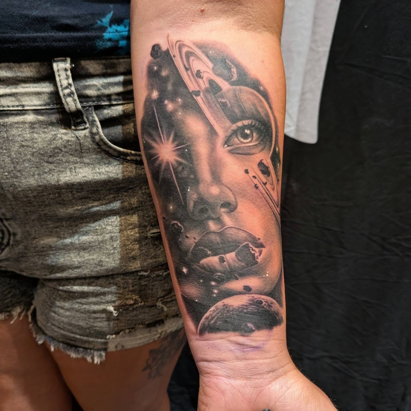 Astronaut realism tattoo on the forearm by James Mullin
