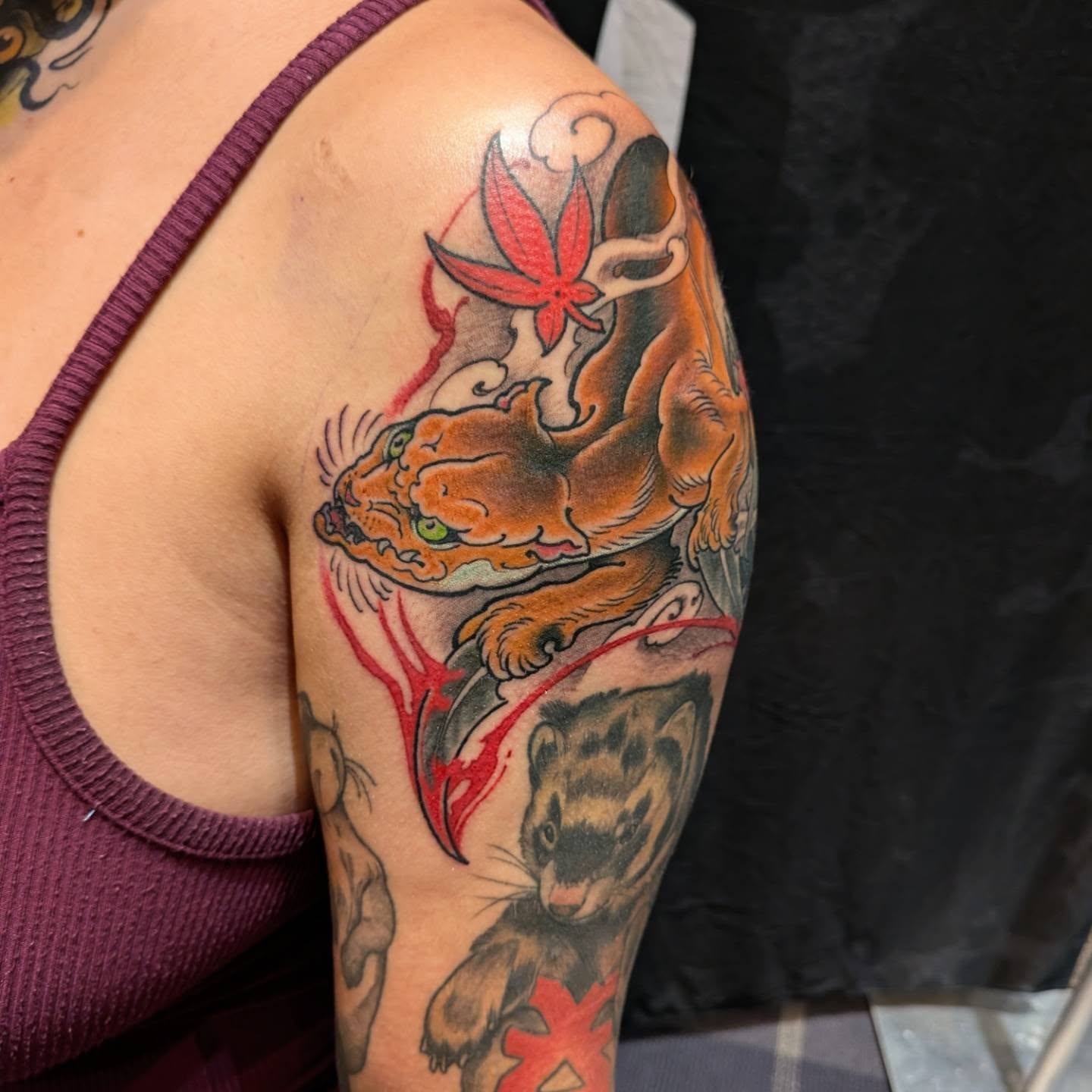 Cat and ferret American traditional tattoo on the upper arm by James Mullin