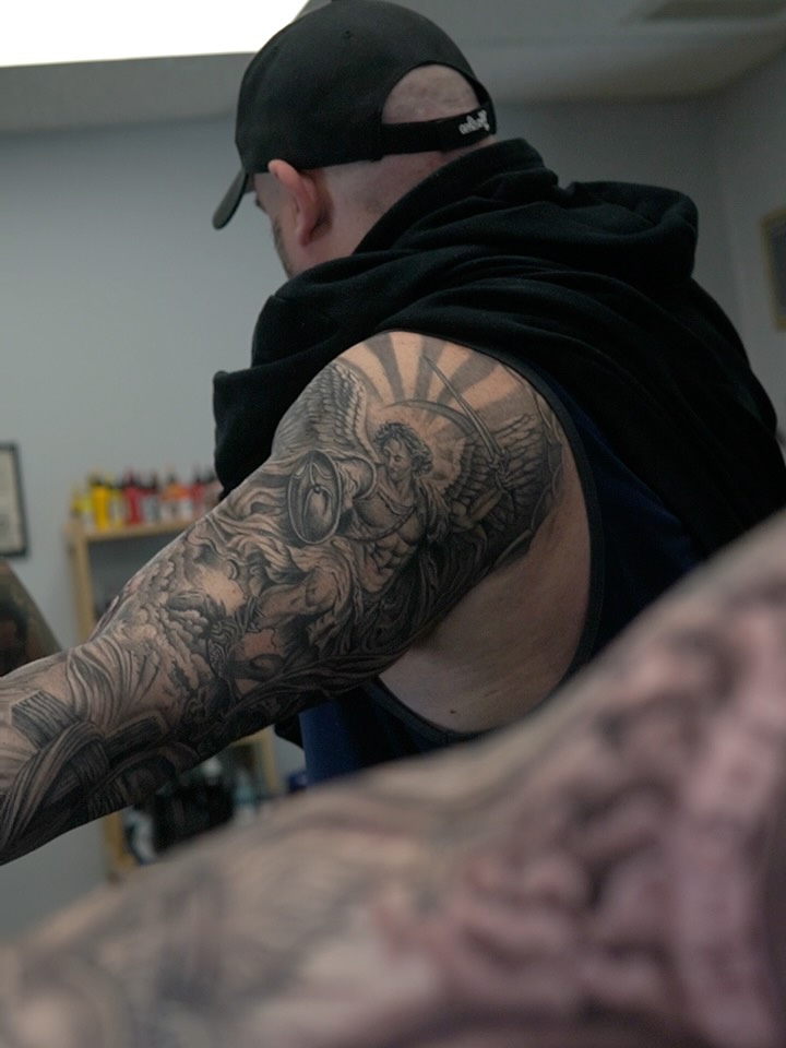 Angelic figure realism tattoo on the upper arm by Sebastian