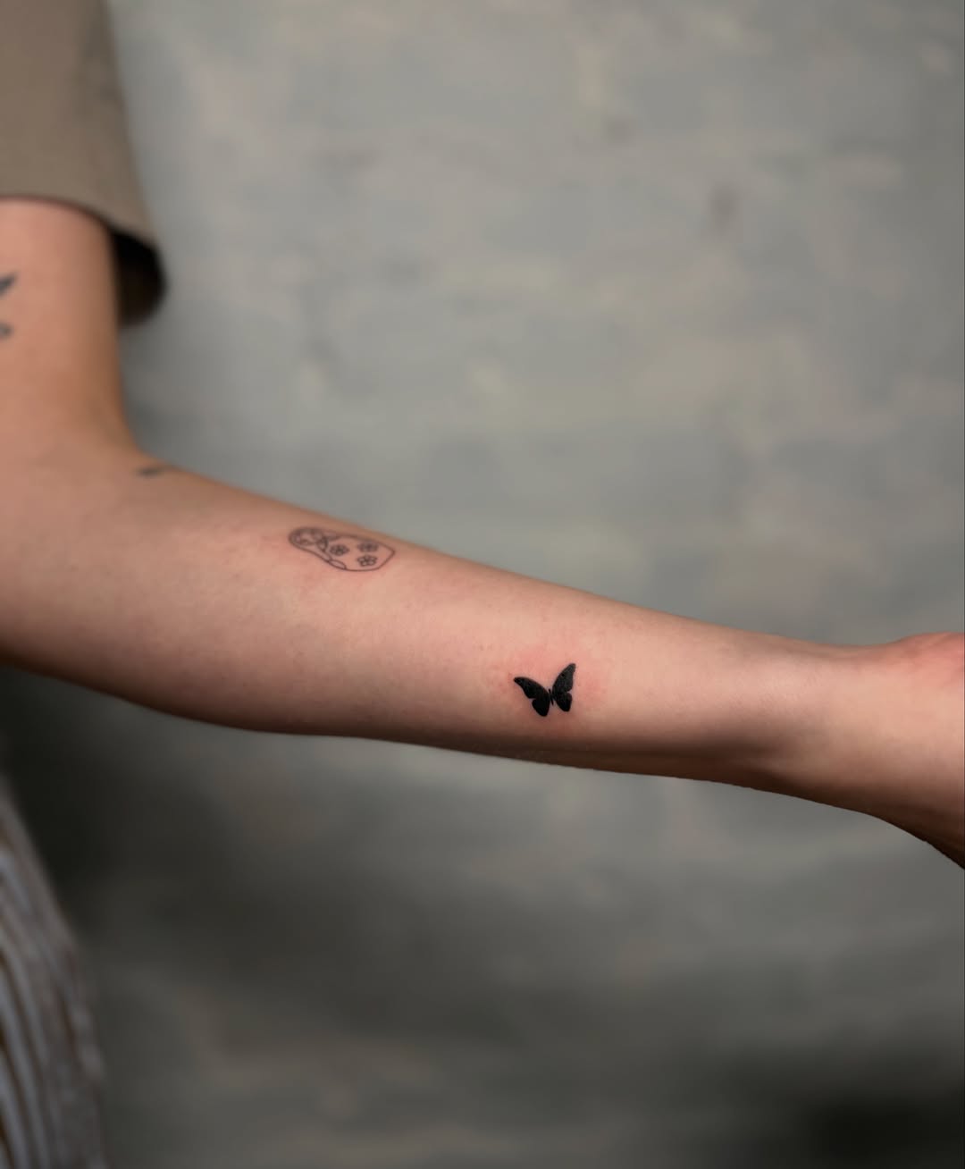 Butterfly minimalist tattoo on the forearm by Fineline Tattoos DFW