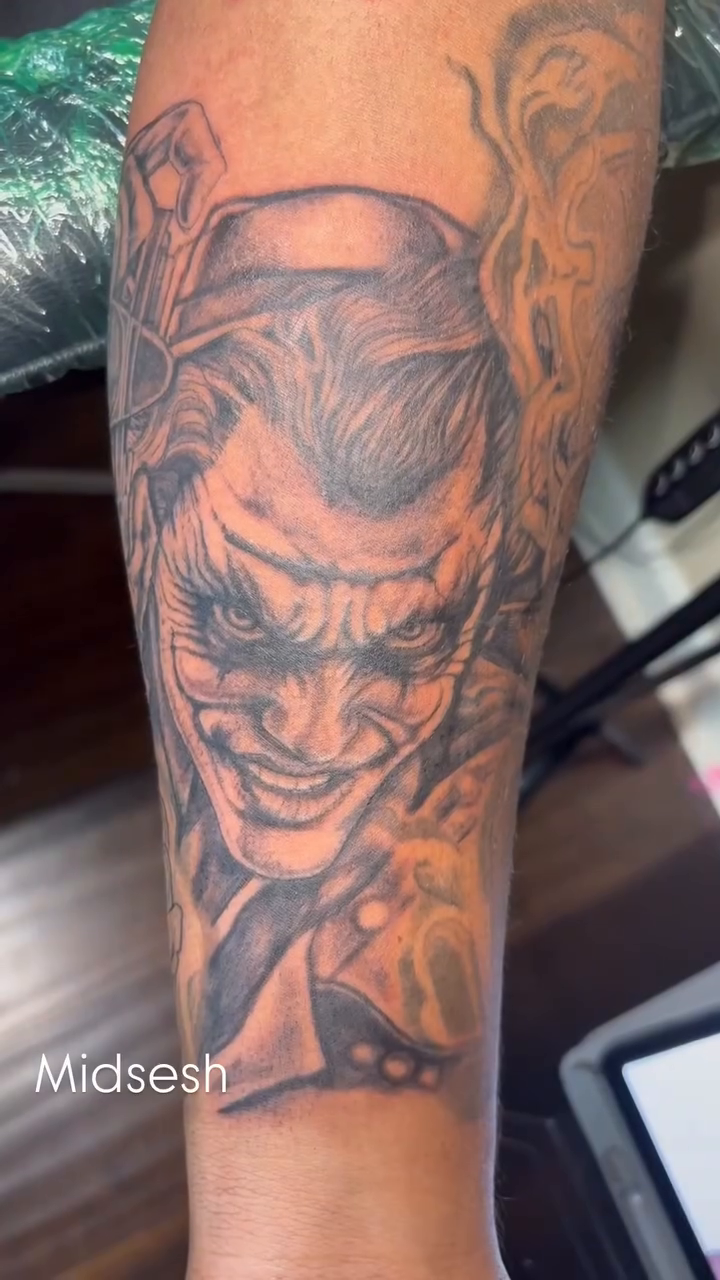 Joker portrait with roses realism tattoo by K.L Tattoo Uptown
