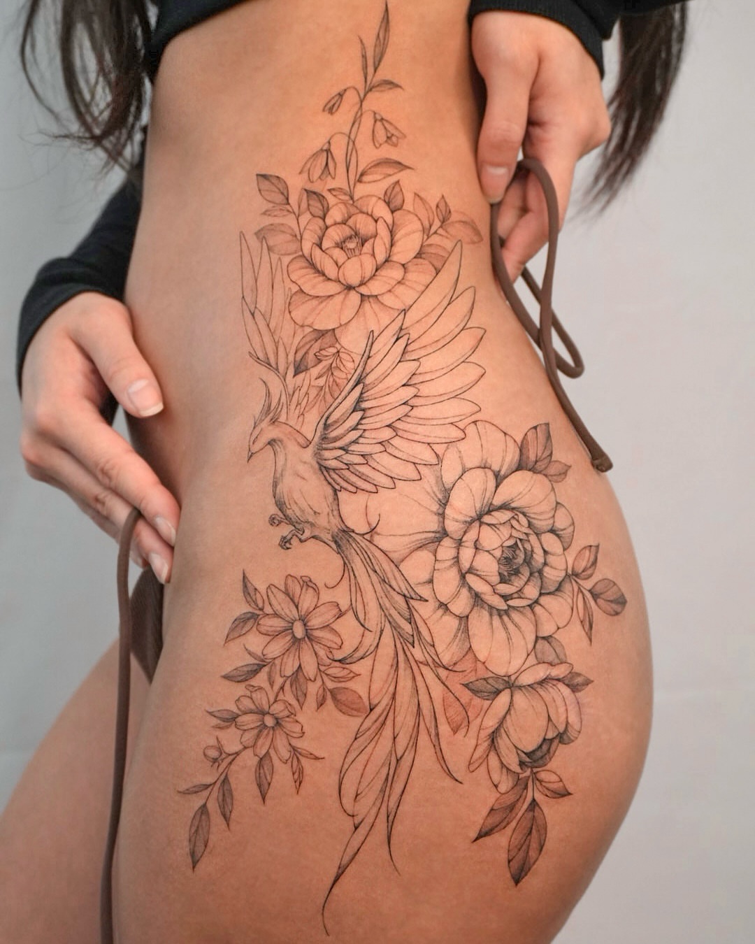 Peacock and flowers black and grey tattoo on the thigh by Hyn[hin]