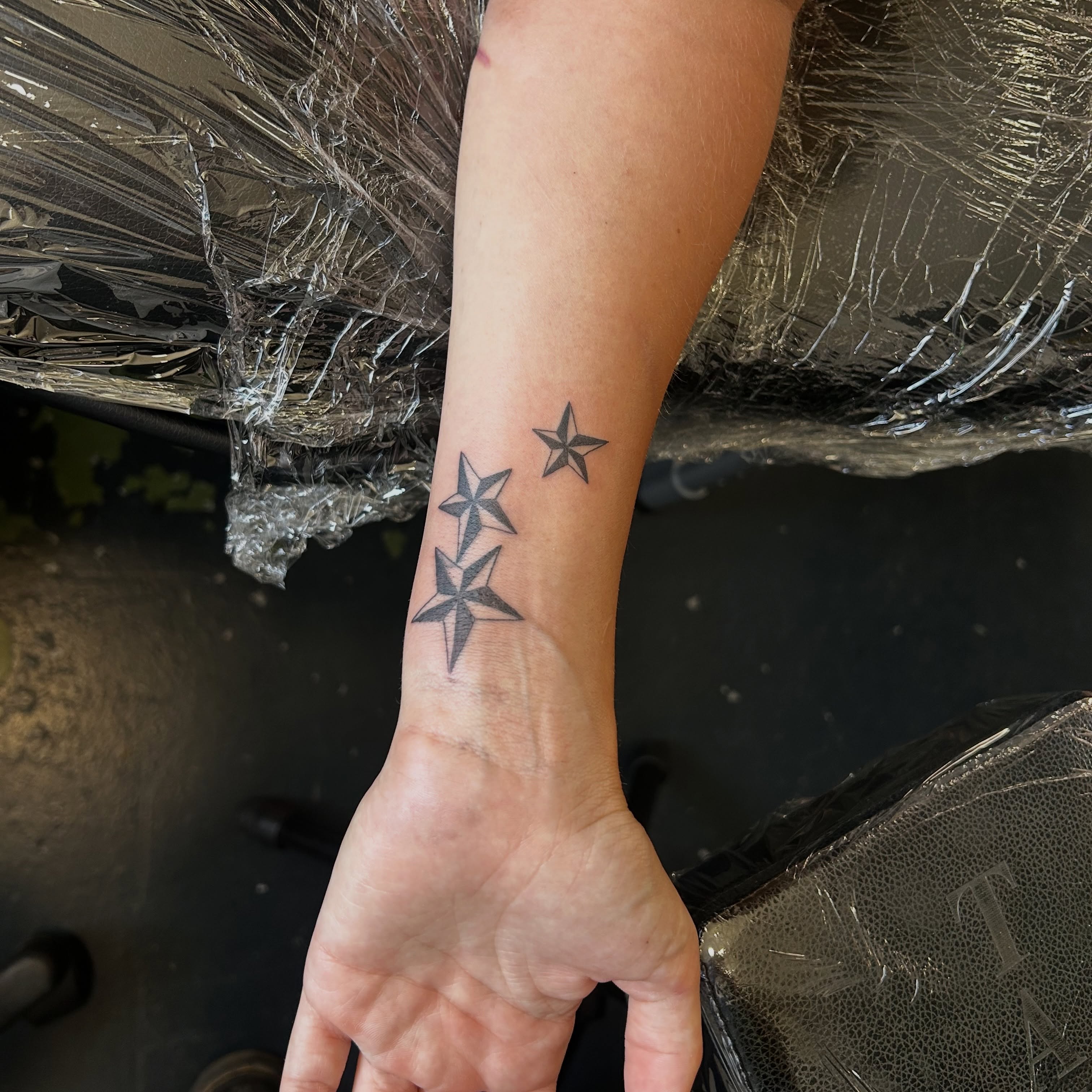 Stars geometric tattoo on the forearm by Phoebe