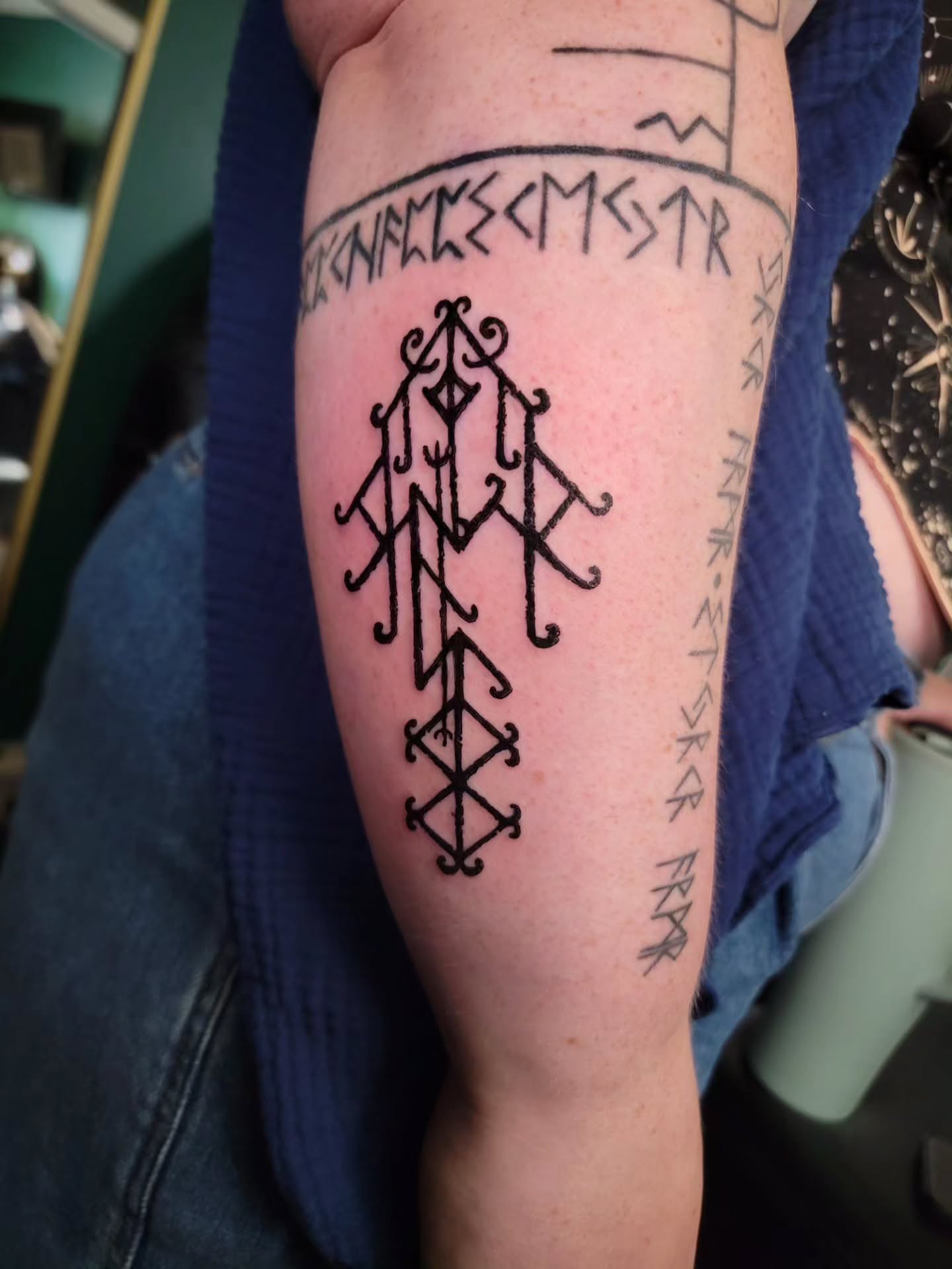 Runic symbol blackwork tattoo on the forearm by Nathan Harkins-Oberbeck
