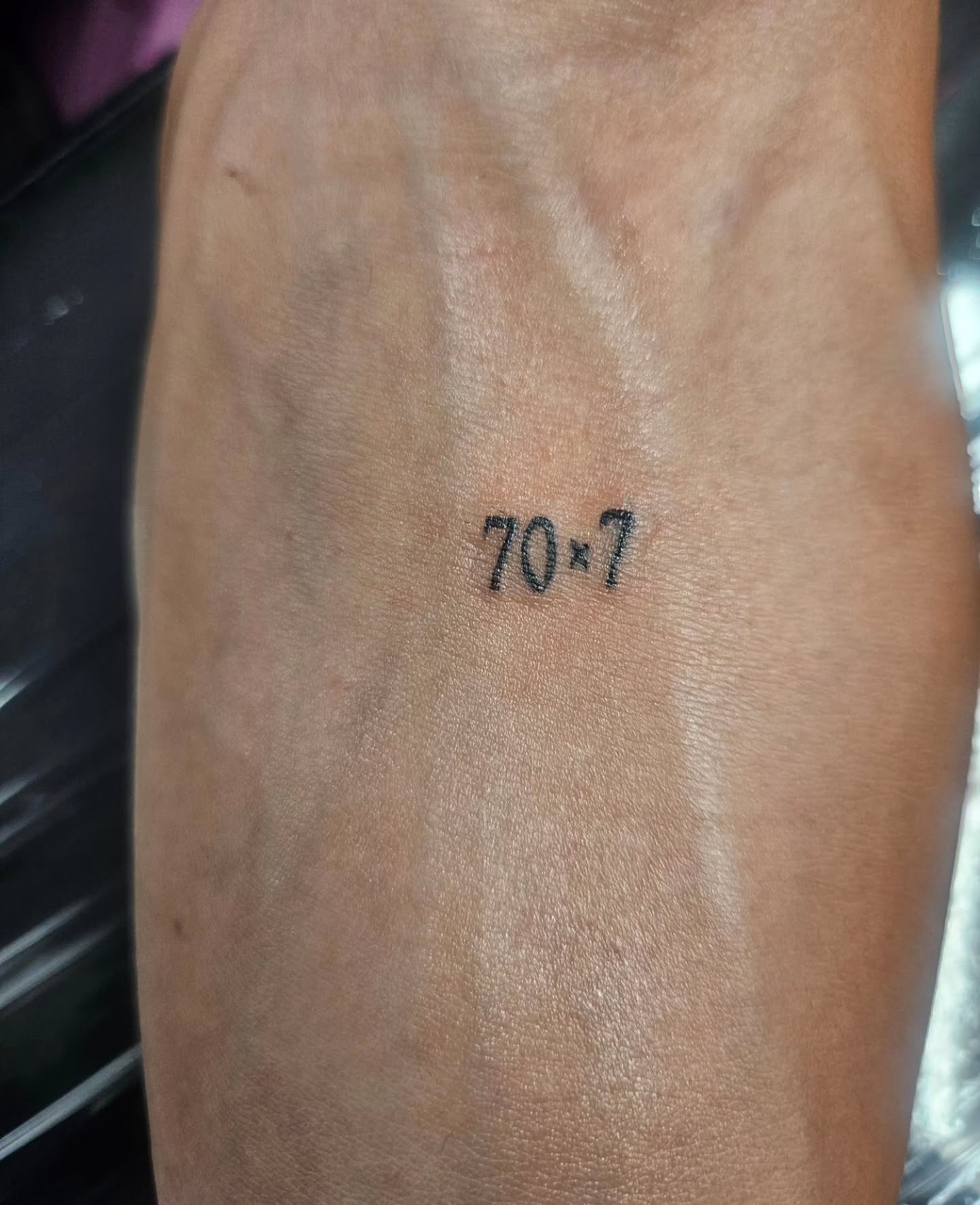 Number lettering script tattoo on the forearm by Mischief π€