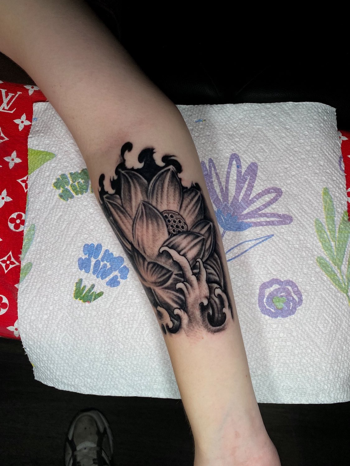 Lotus flower black and grey tattoo on the forearm by Kelan Mckenna