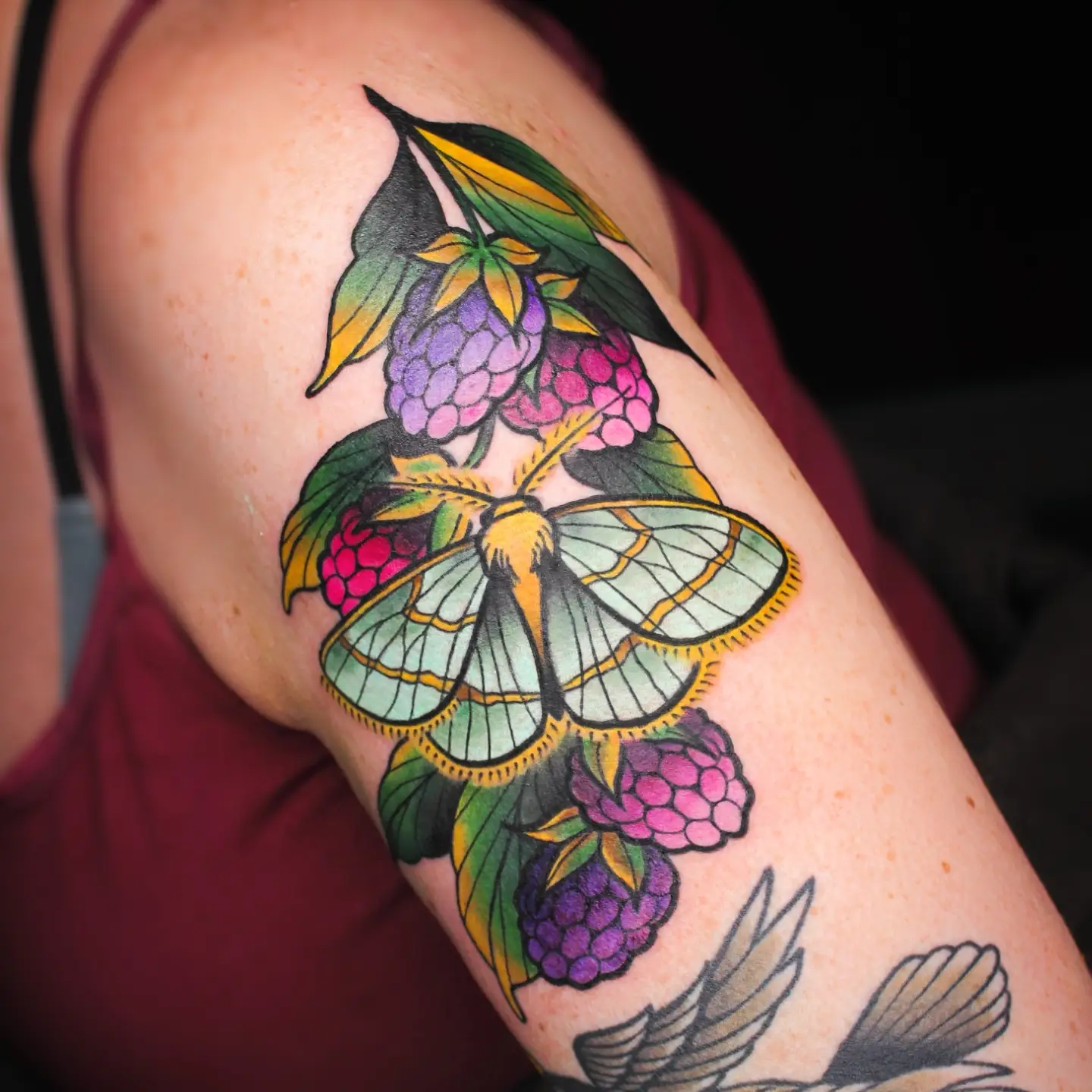 Butterfly and berries American traditional tattoo on the upper arm by ᴍɪʟᴀ ꜱᴀꜱɪᴇᴛᴀ