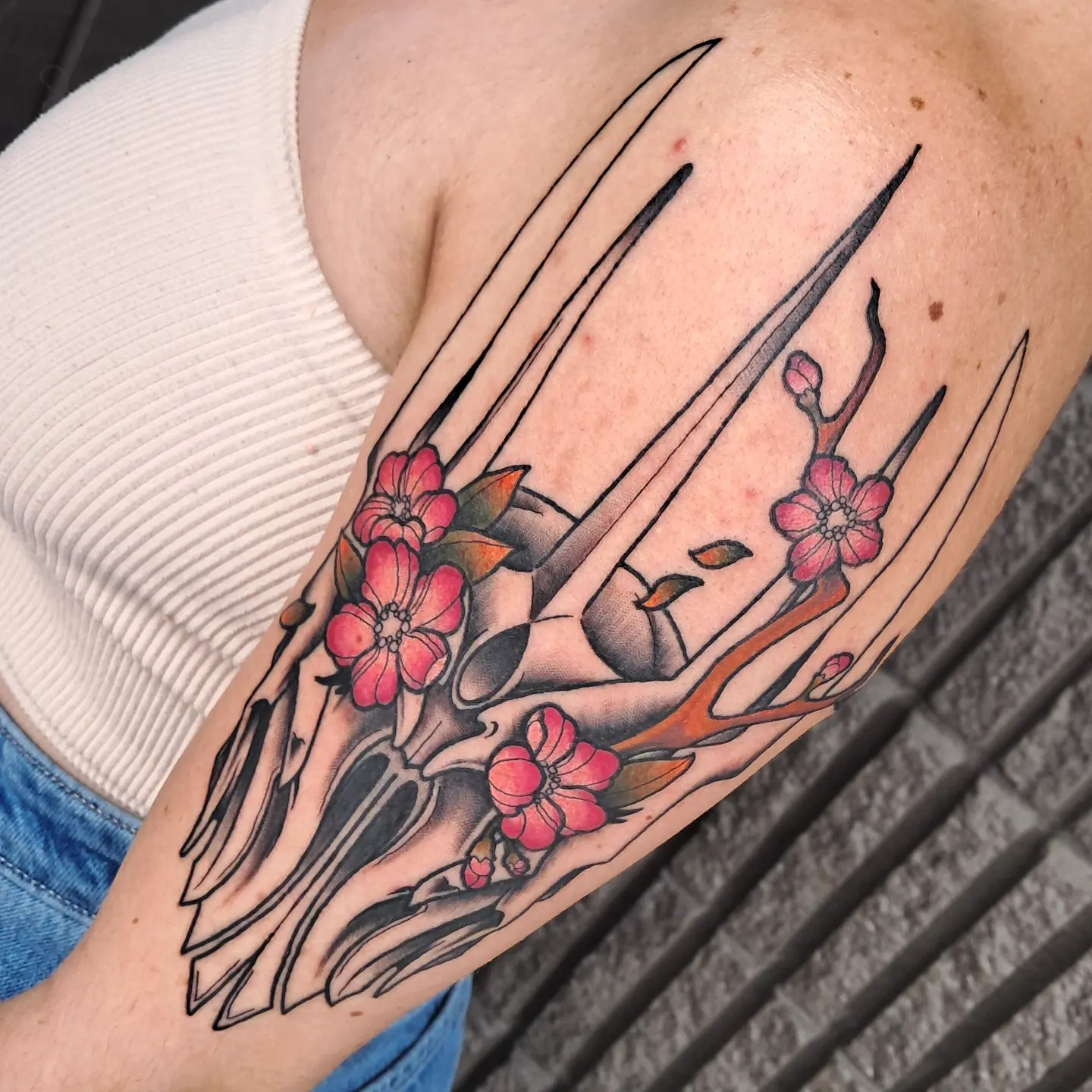 Cherry blossoms and claws japanese irezumi tattoo on the forearm by Erika Hollingsworth