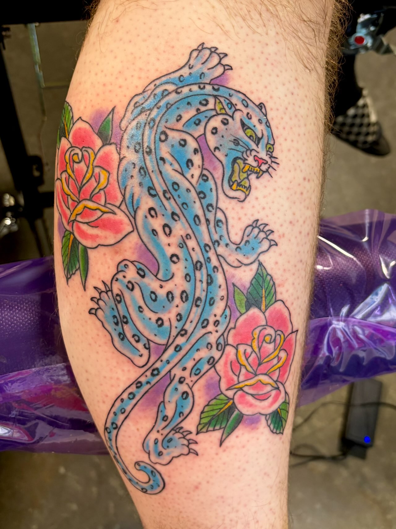 Jaguar and roses American traditional tattoo on the thigh by @rayscott_tattoo