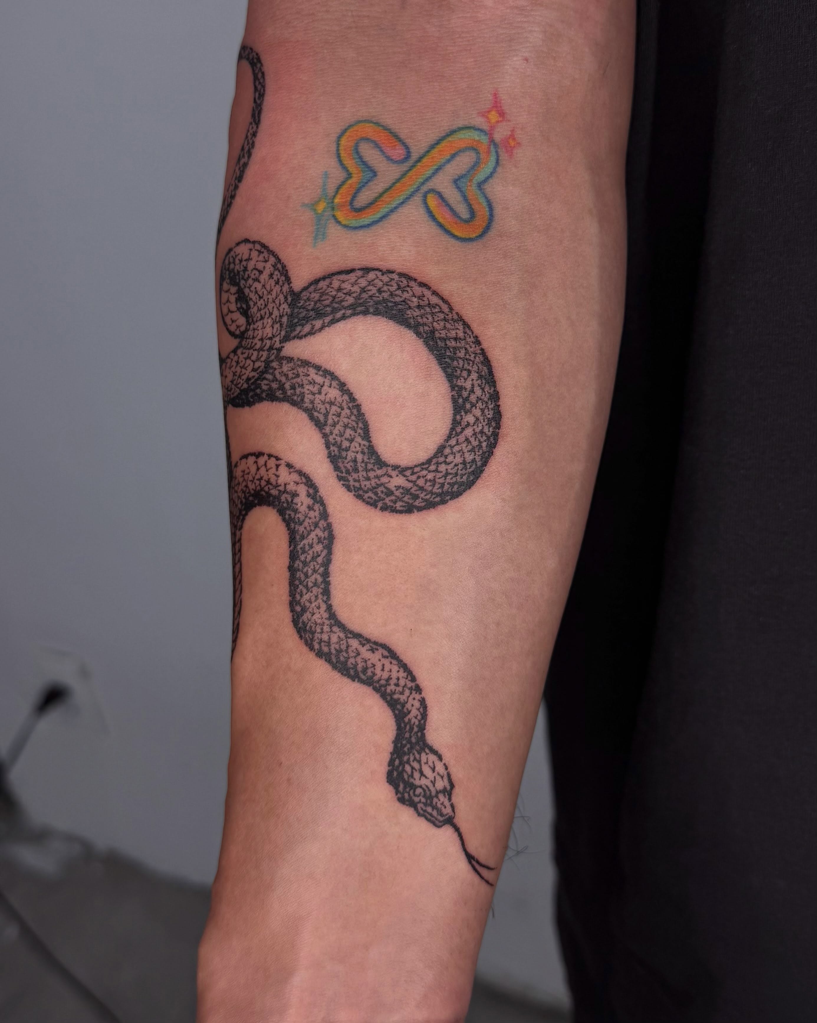 Snake black and grey tattoo on the forearm by Anh Đan