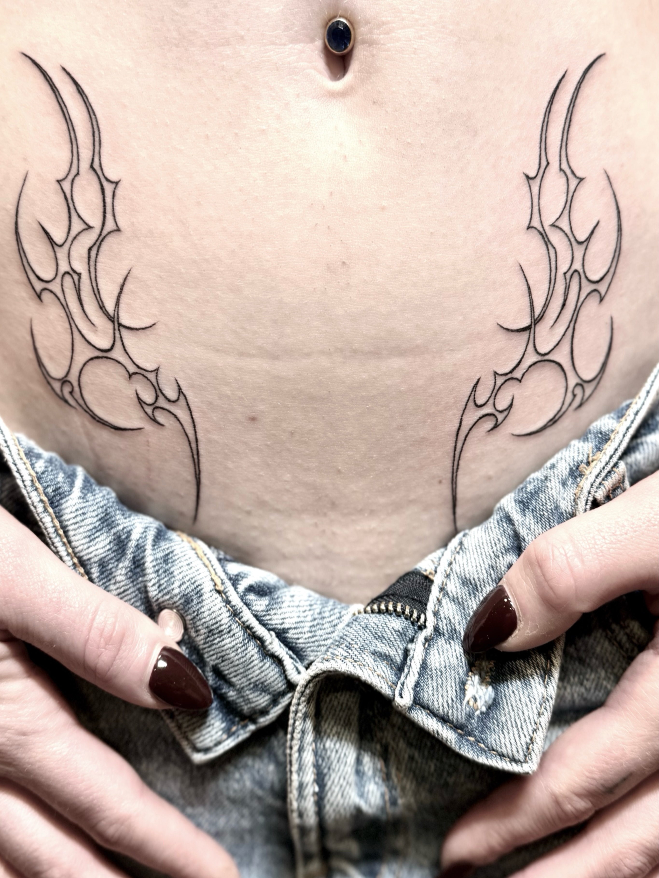Flame tribal tattoo on the torso by @luckybunnytat2