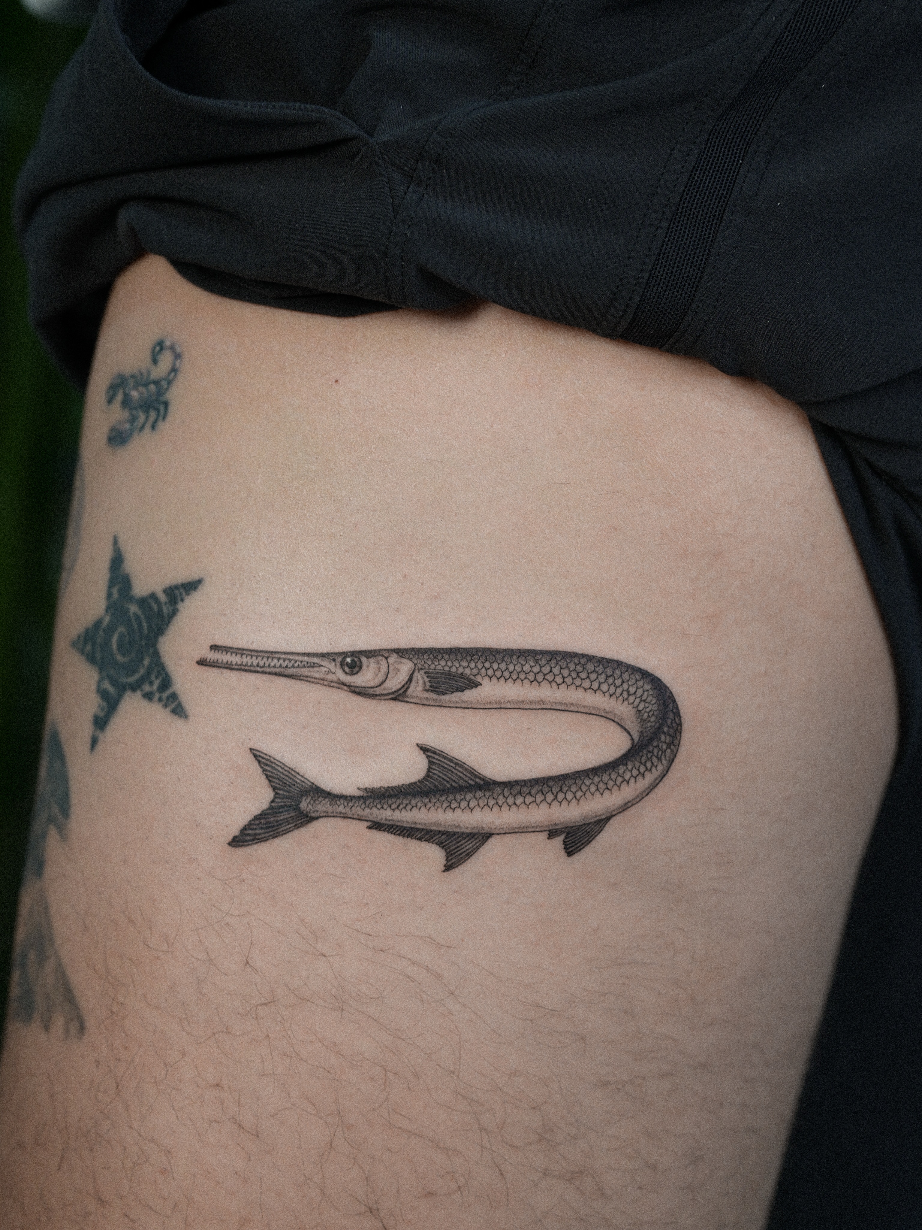 Fish black and grey tattoo on the thigh by Jena