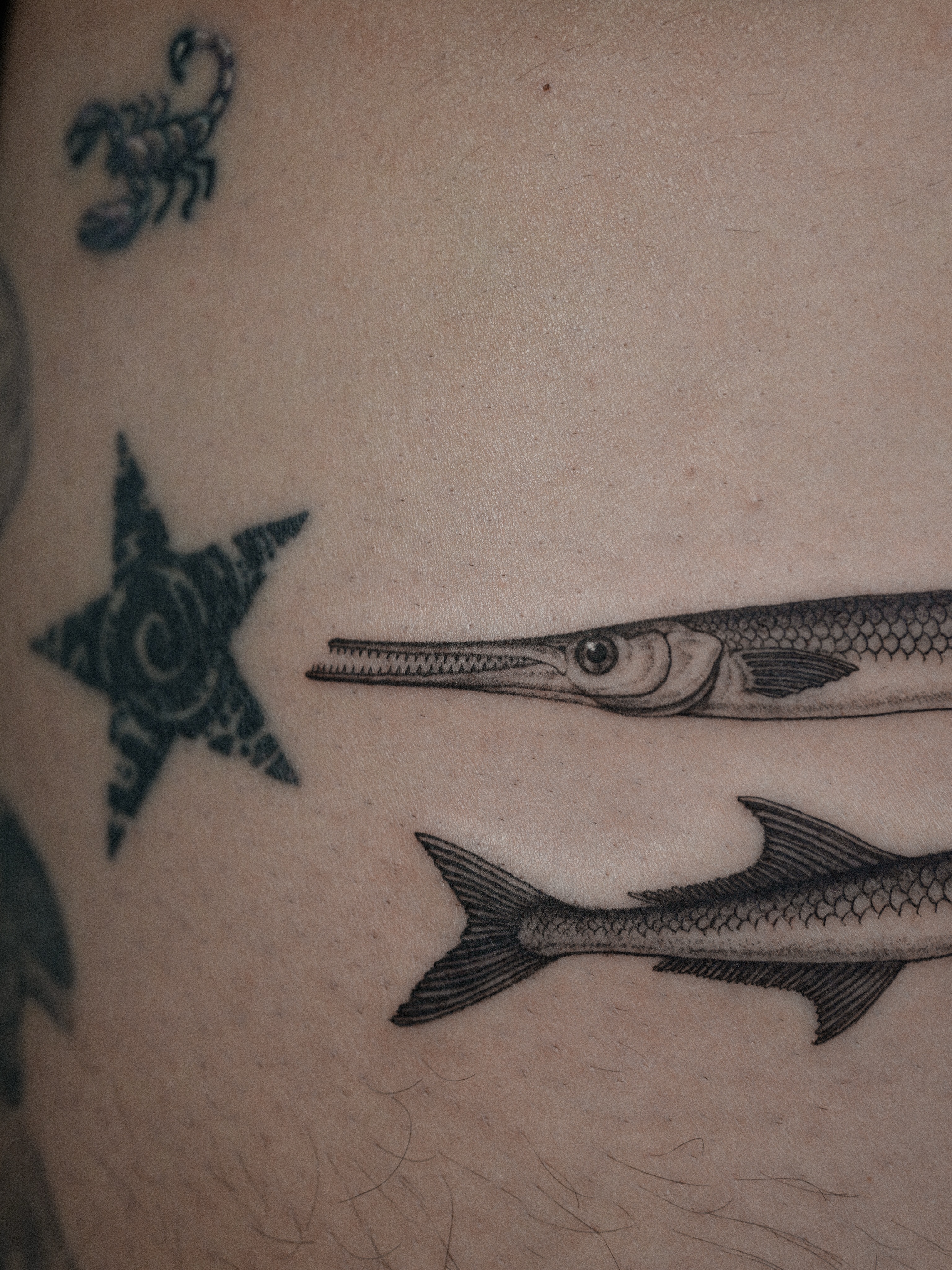 Fish black and grey tattoo on the thigh by Jena