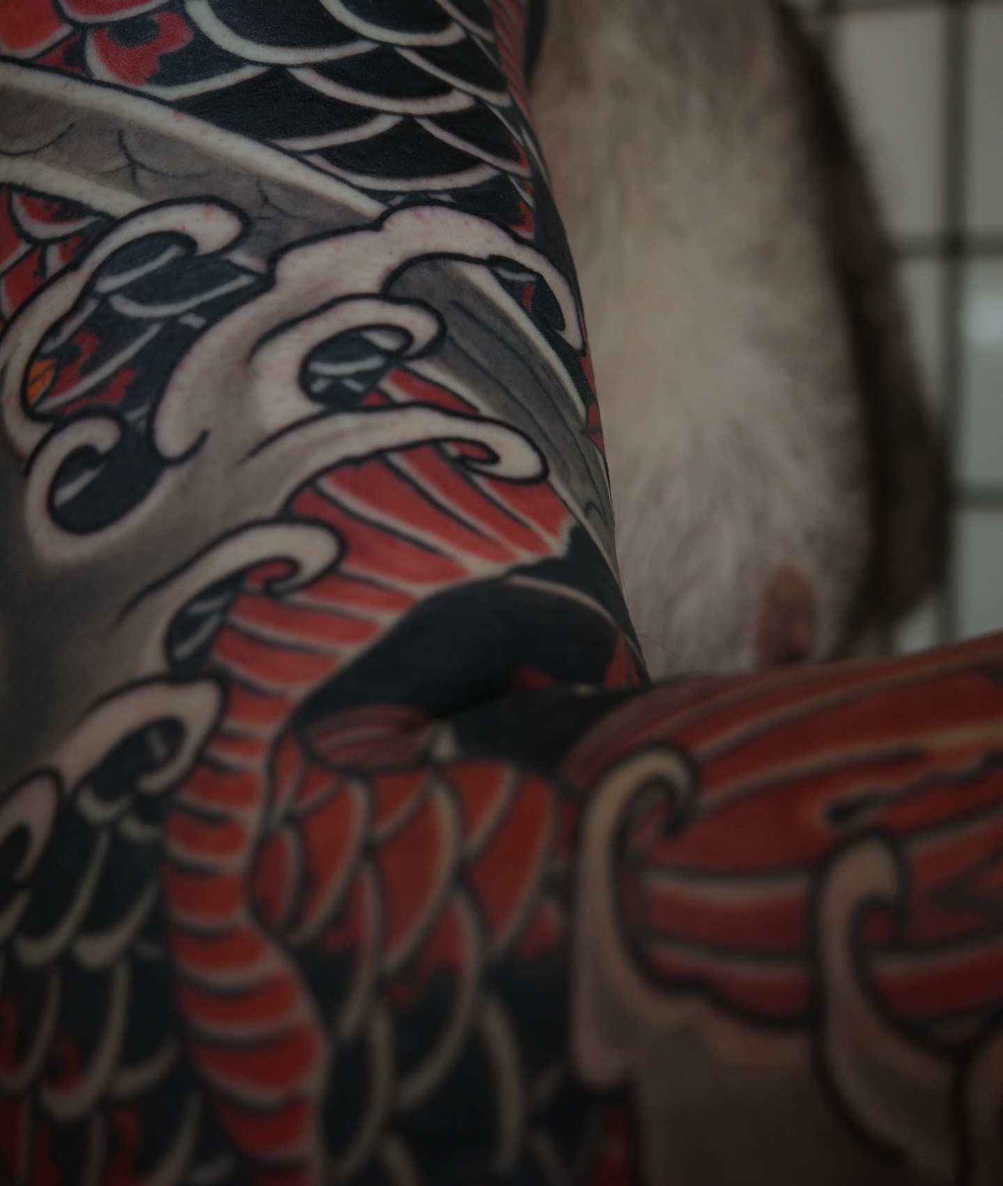 Koi fish American traditional tattoo on the upper arm by Innokenty Meshchakov, Portland, Oregon