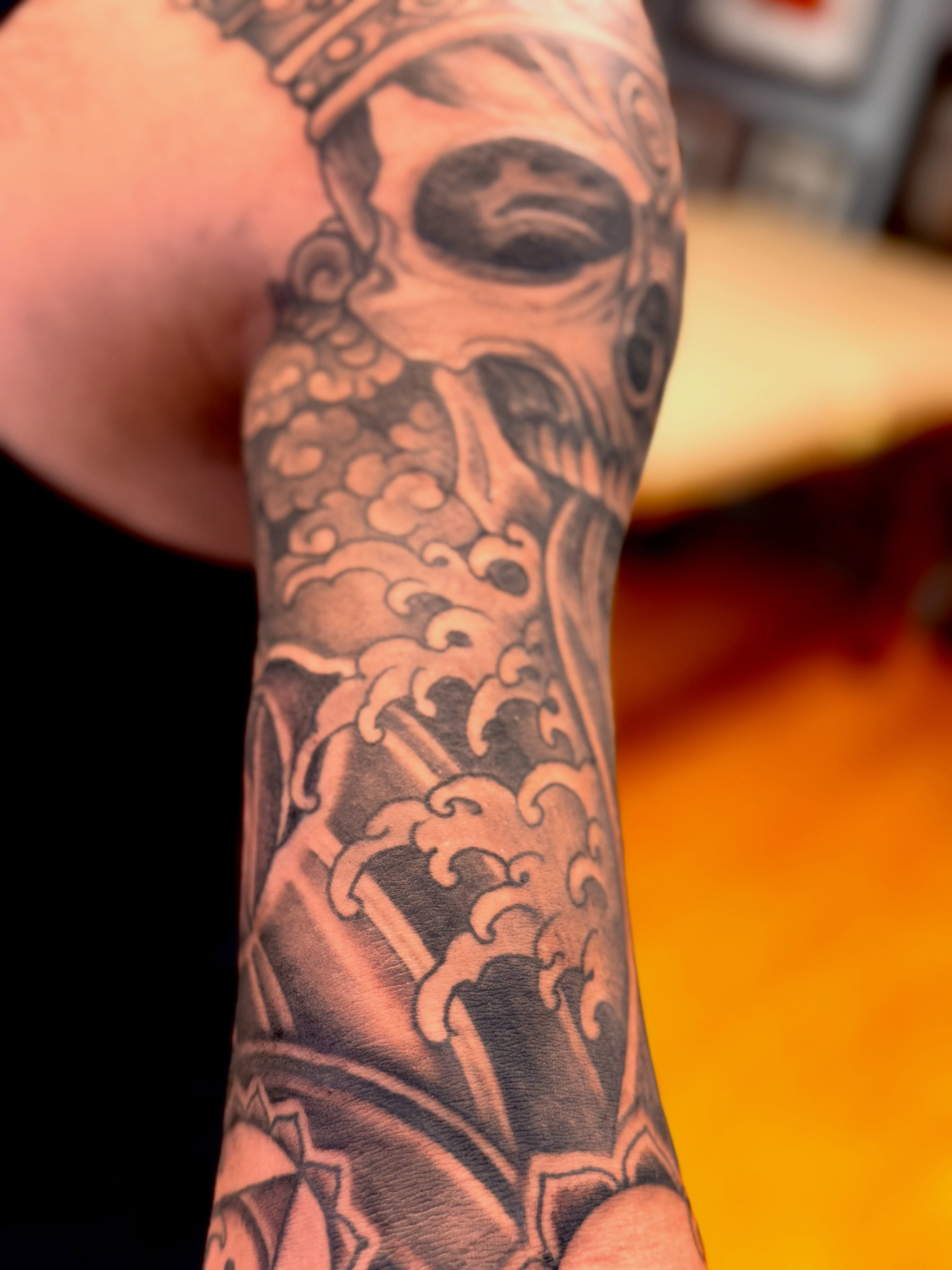 Skull and waves japanese irezumi tattoo on the forearm by Brian Hutflies