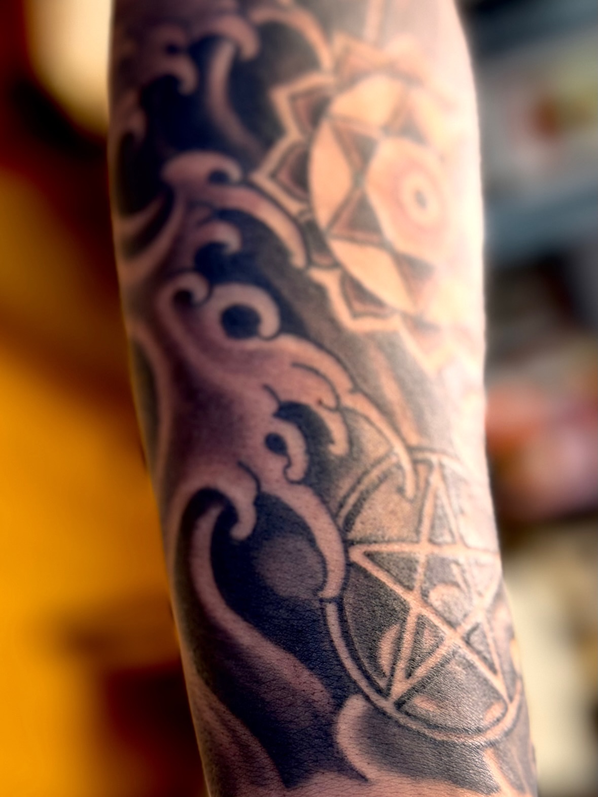 Pentagram and mandala geometric tattoo on the forearm by Brian Hutflies