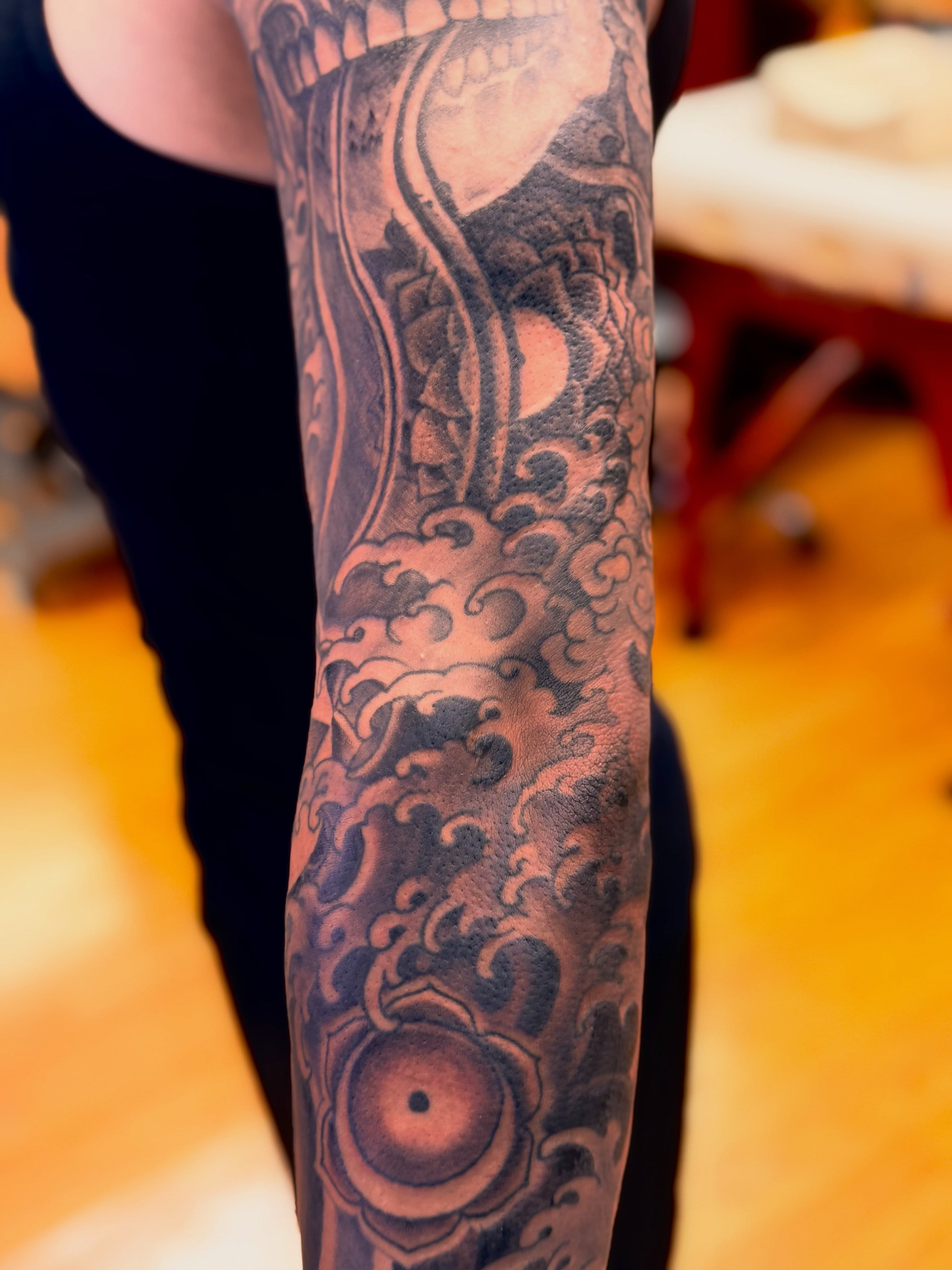 Wave and gear geometric tattoo on the forearm by Brian Hutflies
