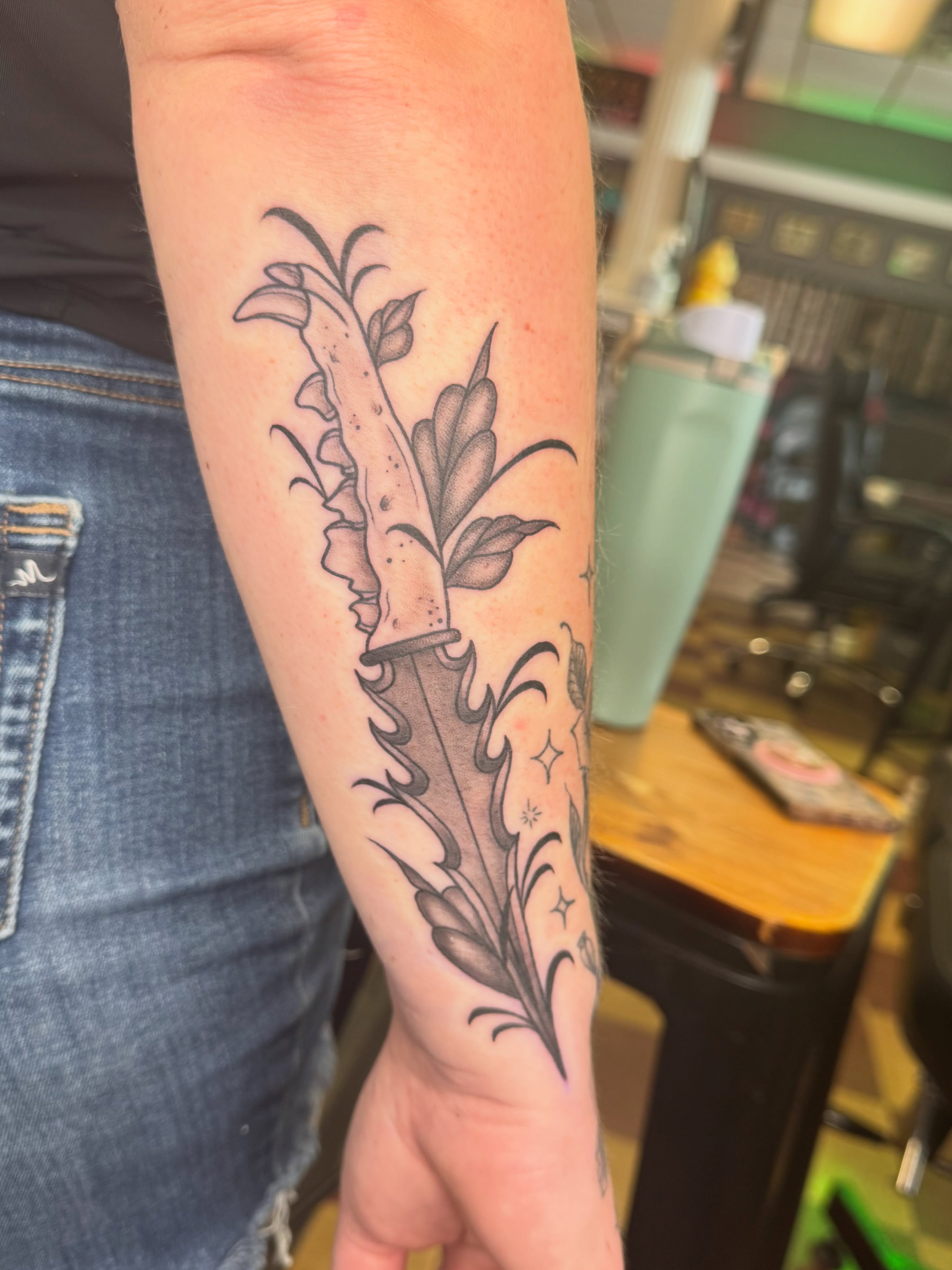 Foxglove plant black and grey tattoo on the forearm by Cora Phelps