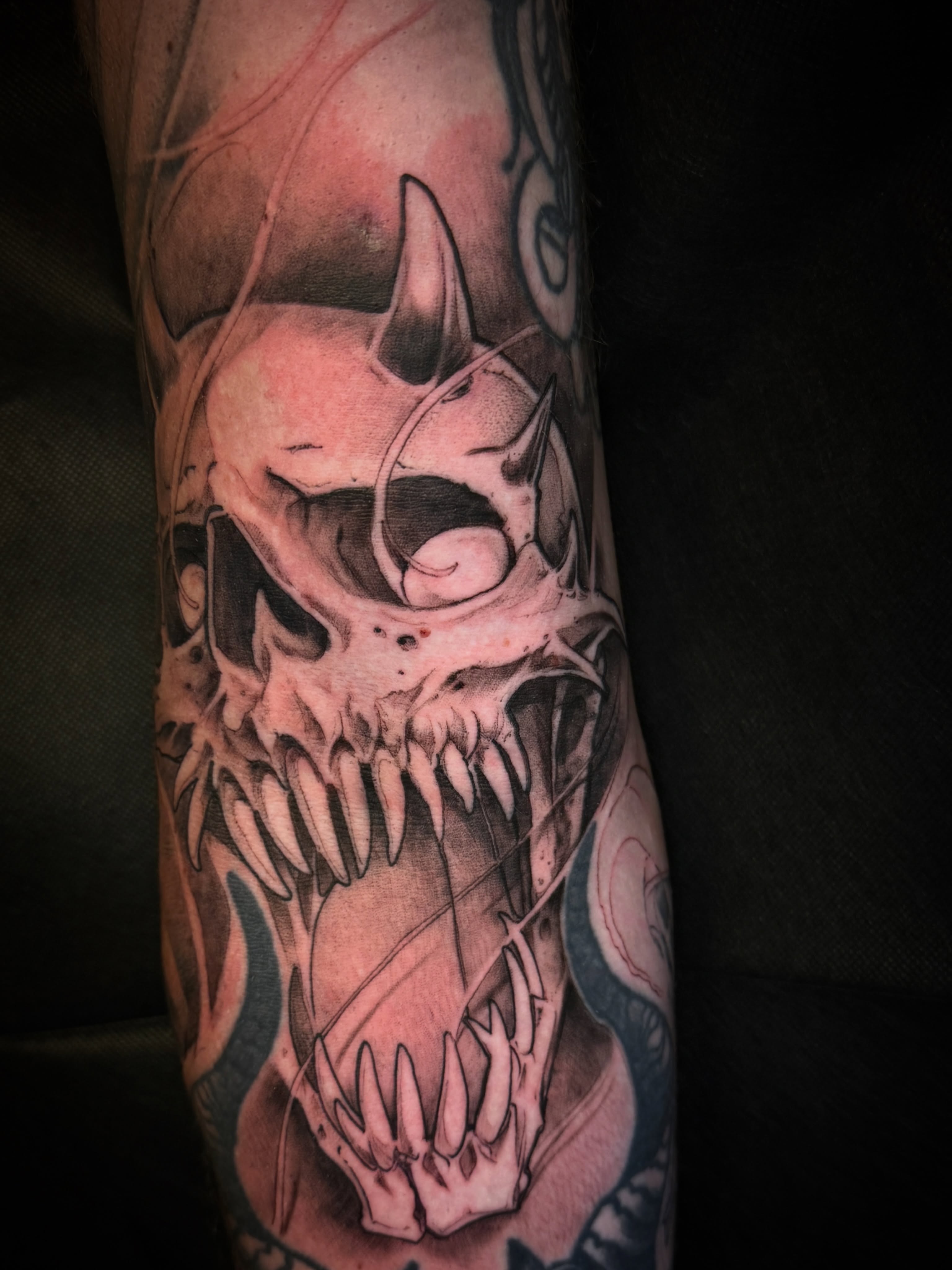 Skull dark realism tattoo on the forearm by Joe Hall