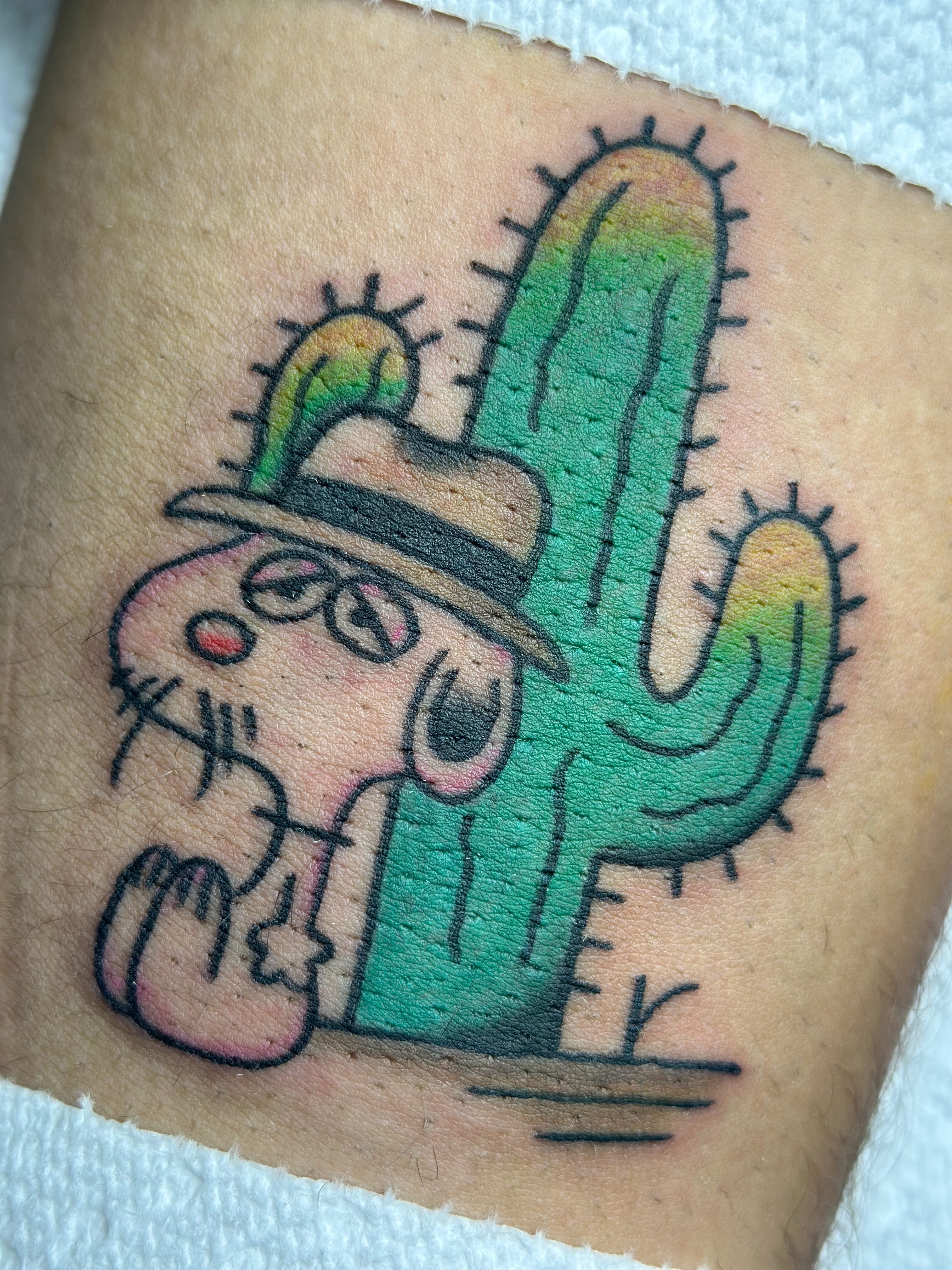 Cactus and cat new school tattoo on the thigh by Lucy Jay