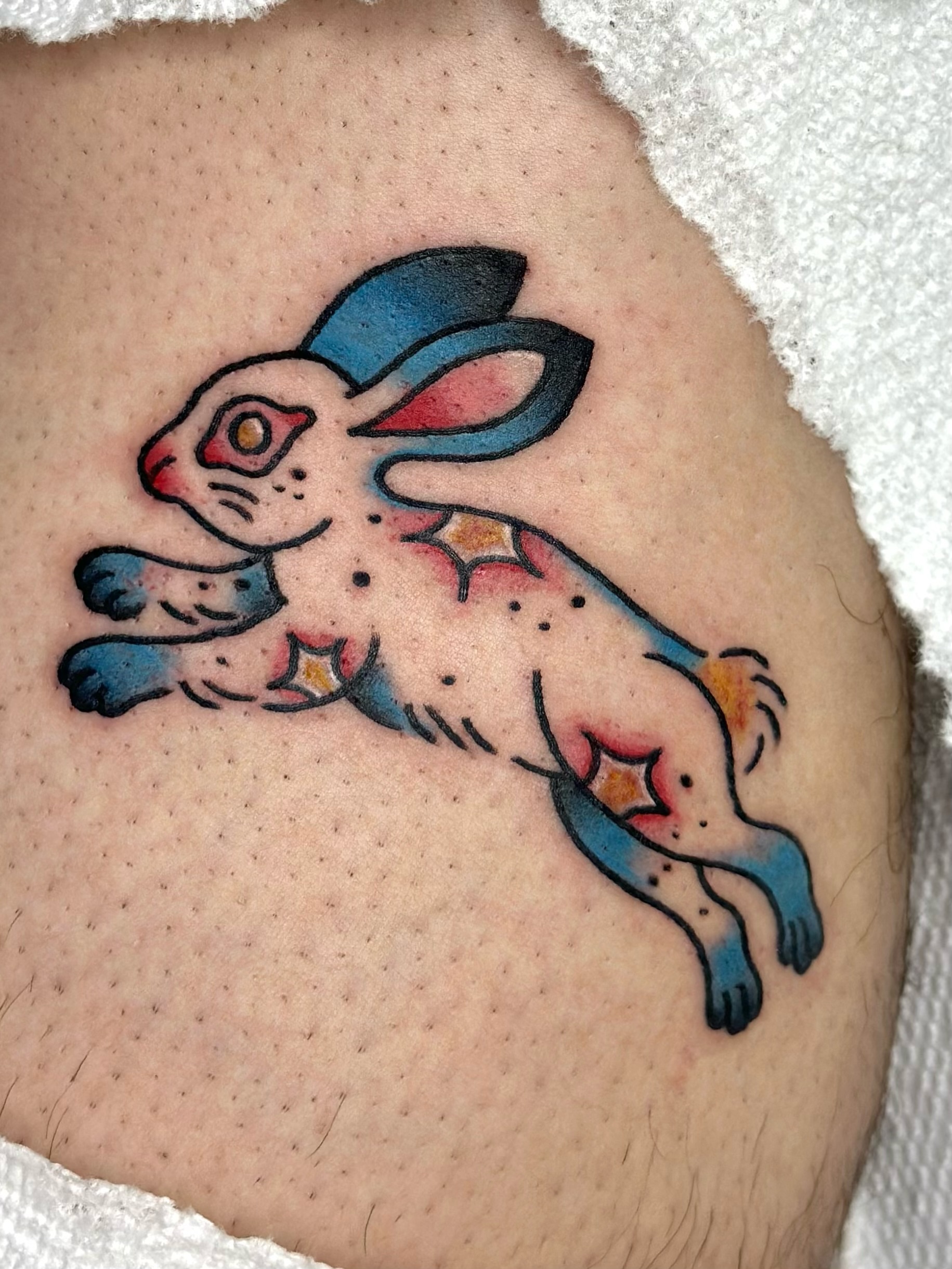 Rabbit American traditional tattoo on the thigh by Lucy Jay
