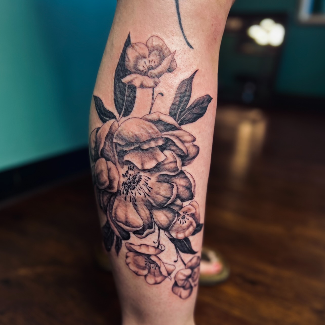 Flowers black and grey tattoo on the forearm by Sydney Rose