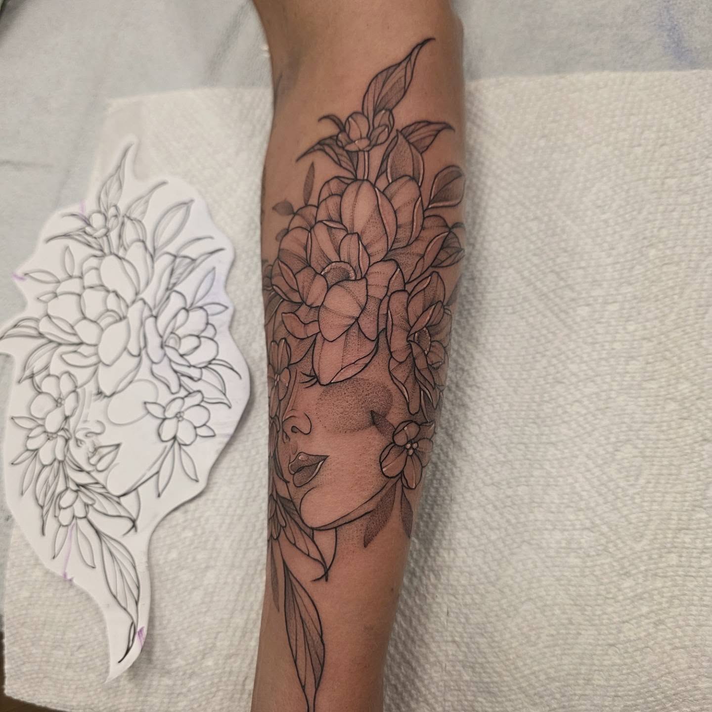 Floral portrait realism tattoo on the forearm by Dani Bond