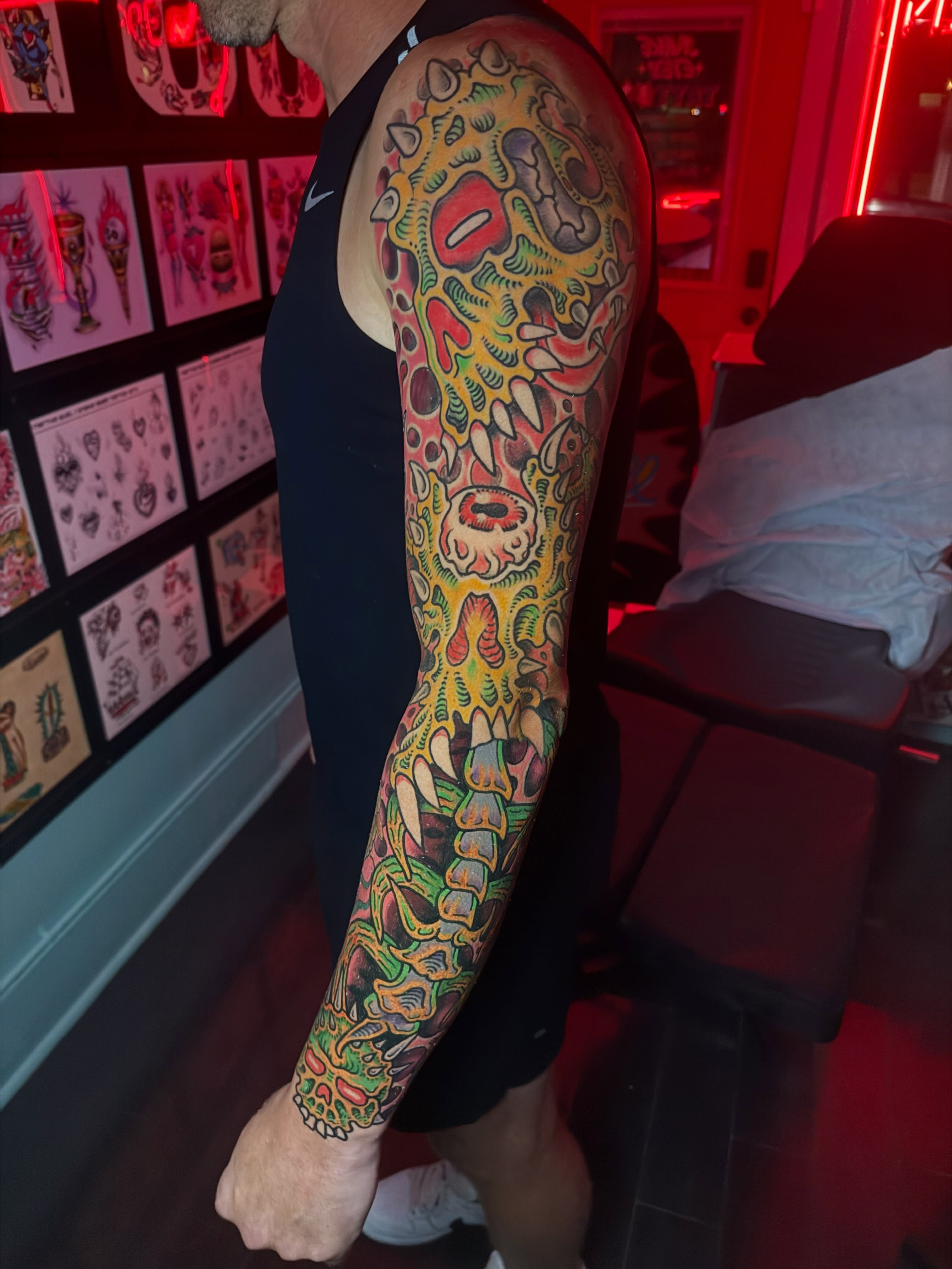 Surrealistic biomechanical creature surrealism tattoo on the forearm by Chris Bishop