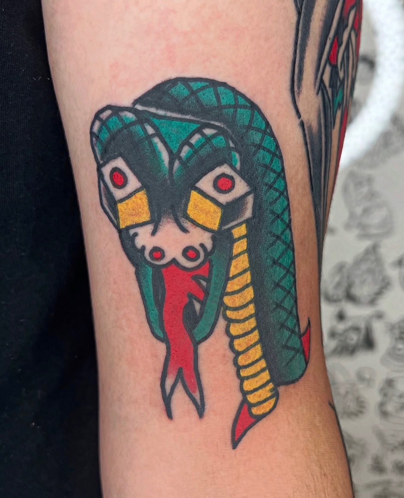 Snake American traditional tattoo on the forearm by Nestor Zelaya