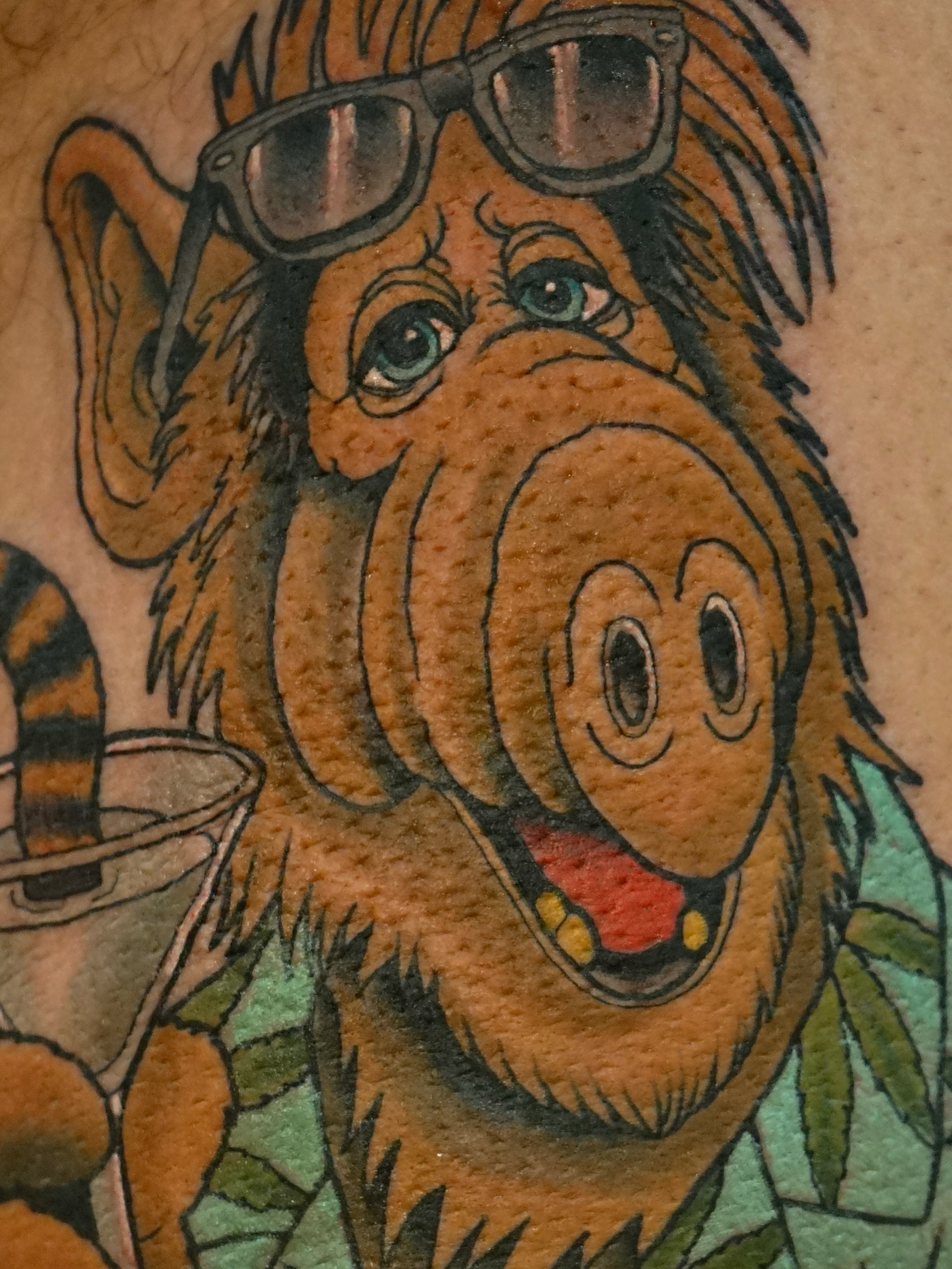 Monkey American traditional tattoo on the upper arm by Tyler Harrington