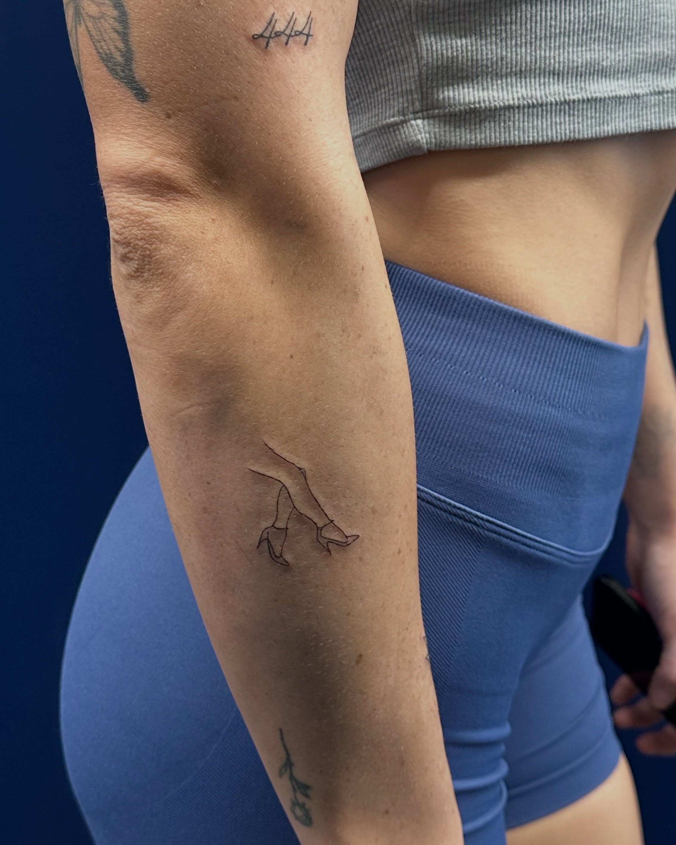 High heels fine line tattoo on the forearm by Tattoo Takayo
